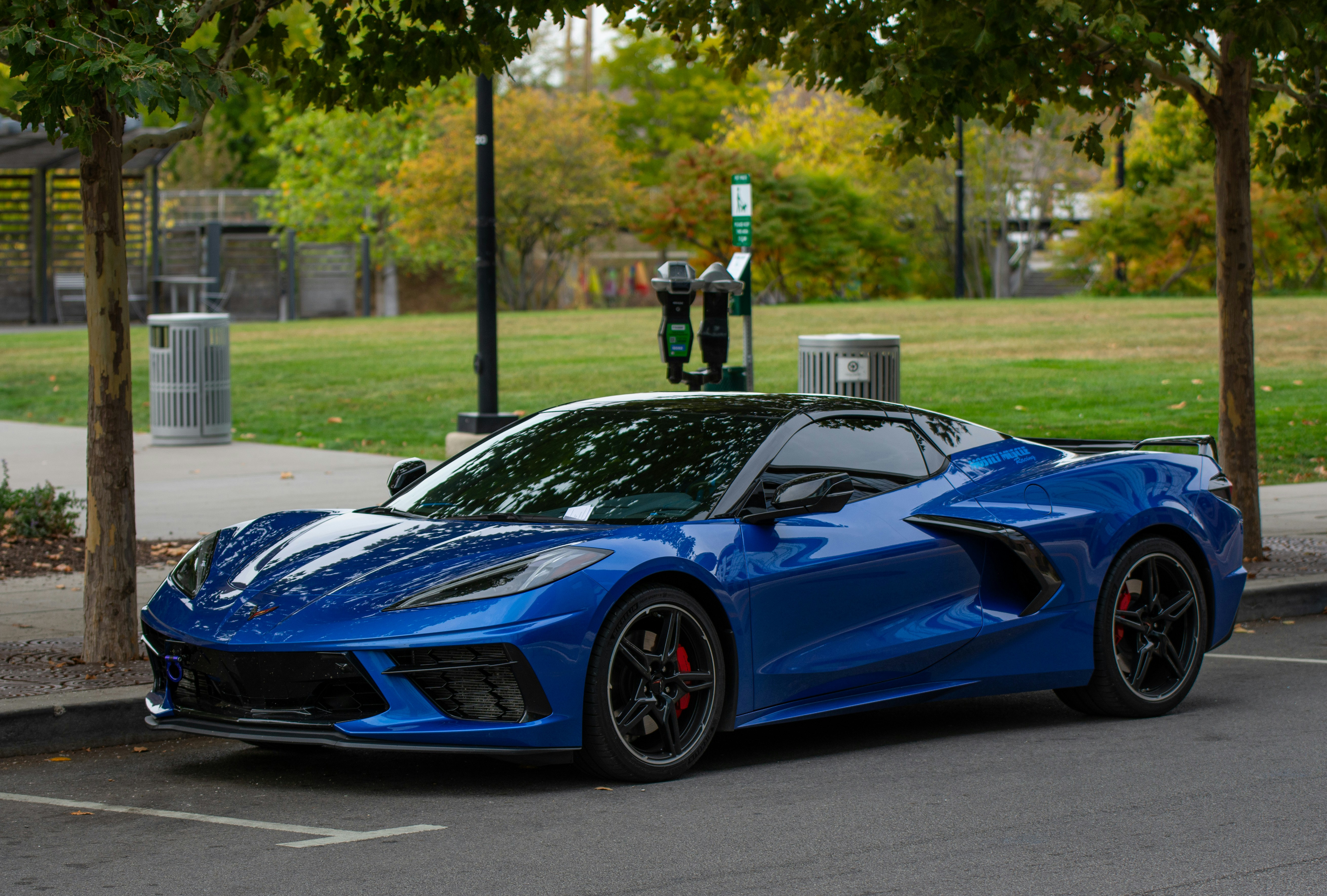 A sleek blue sports car parked outdoors.