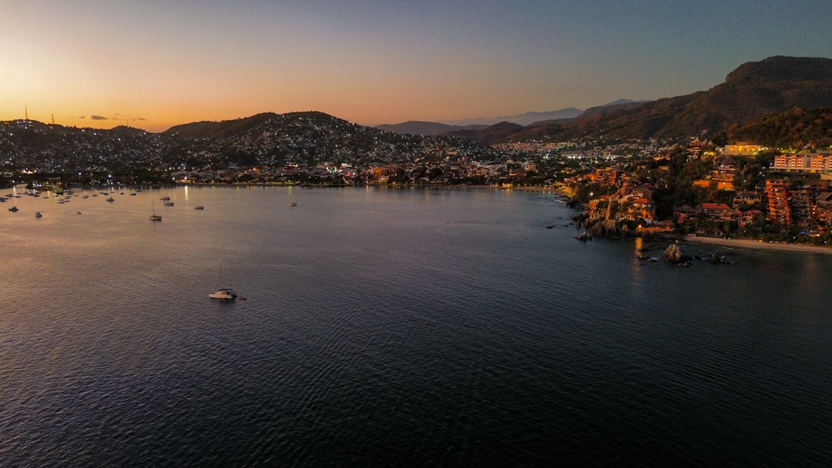 Coastal town at sunset with boats in the harbor