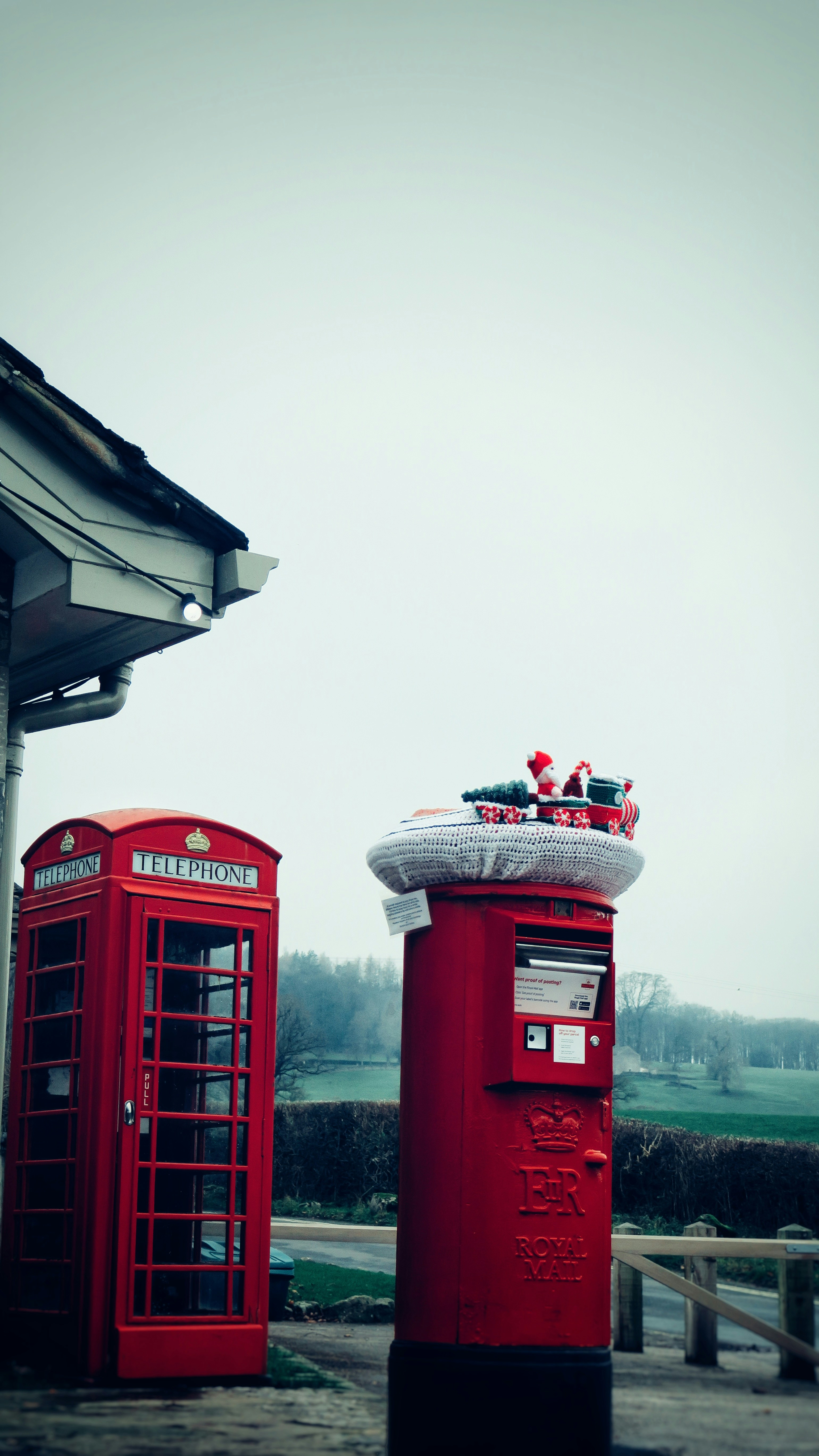 Red british telephone box and post box with decorations