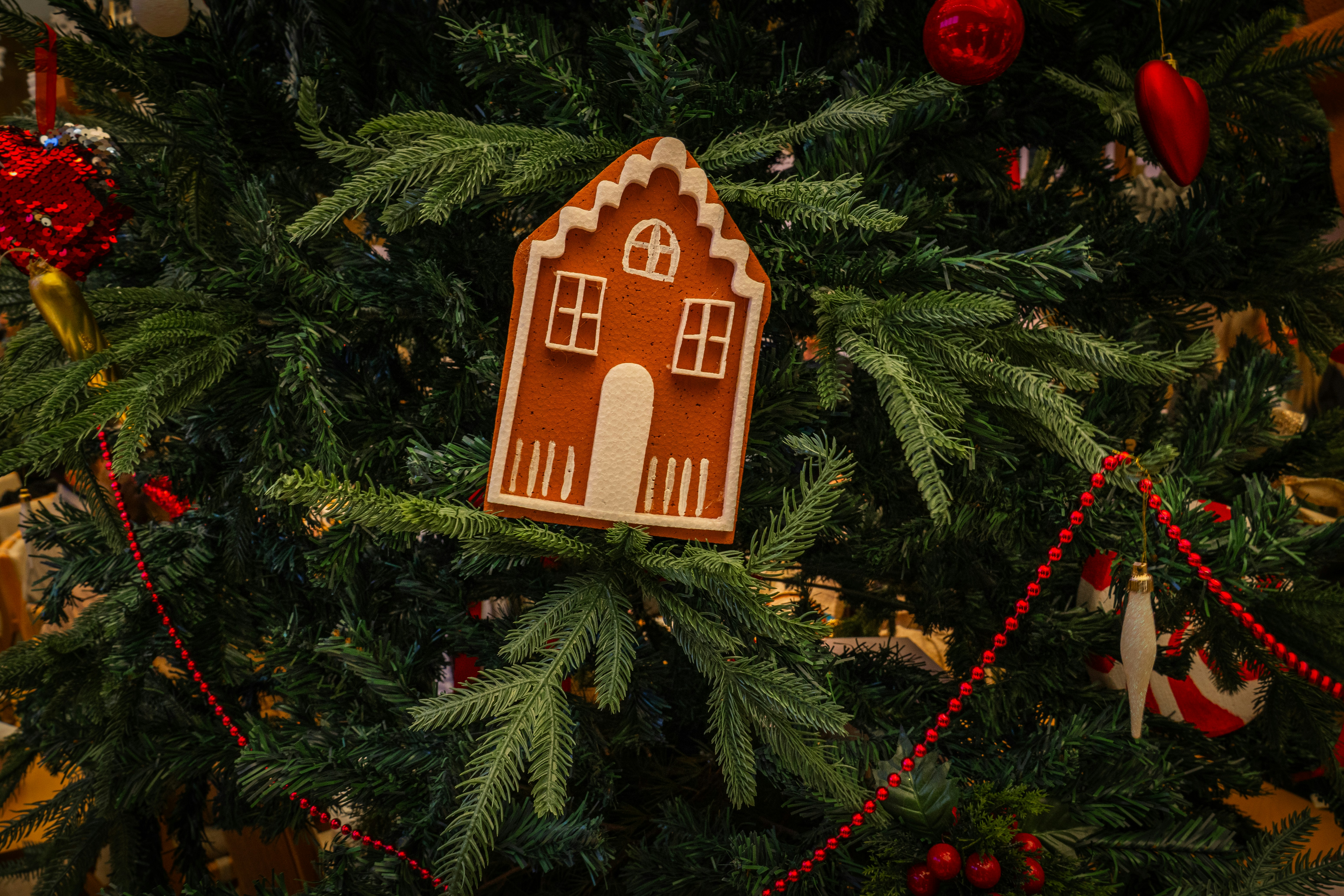 Gingerbread house ornament on a christmas tree
