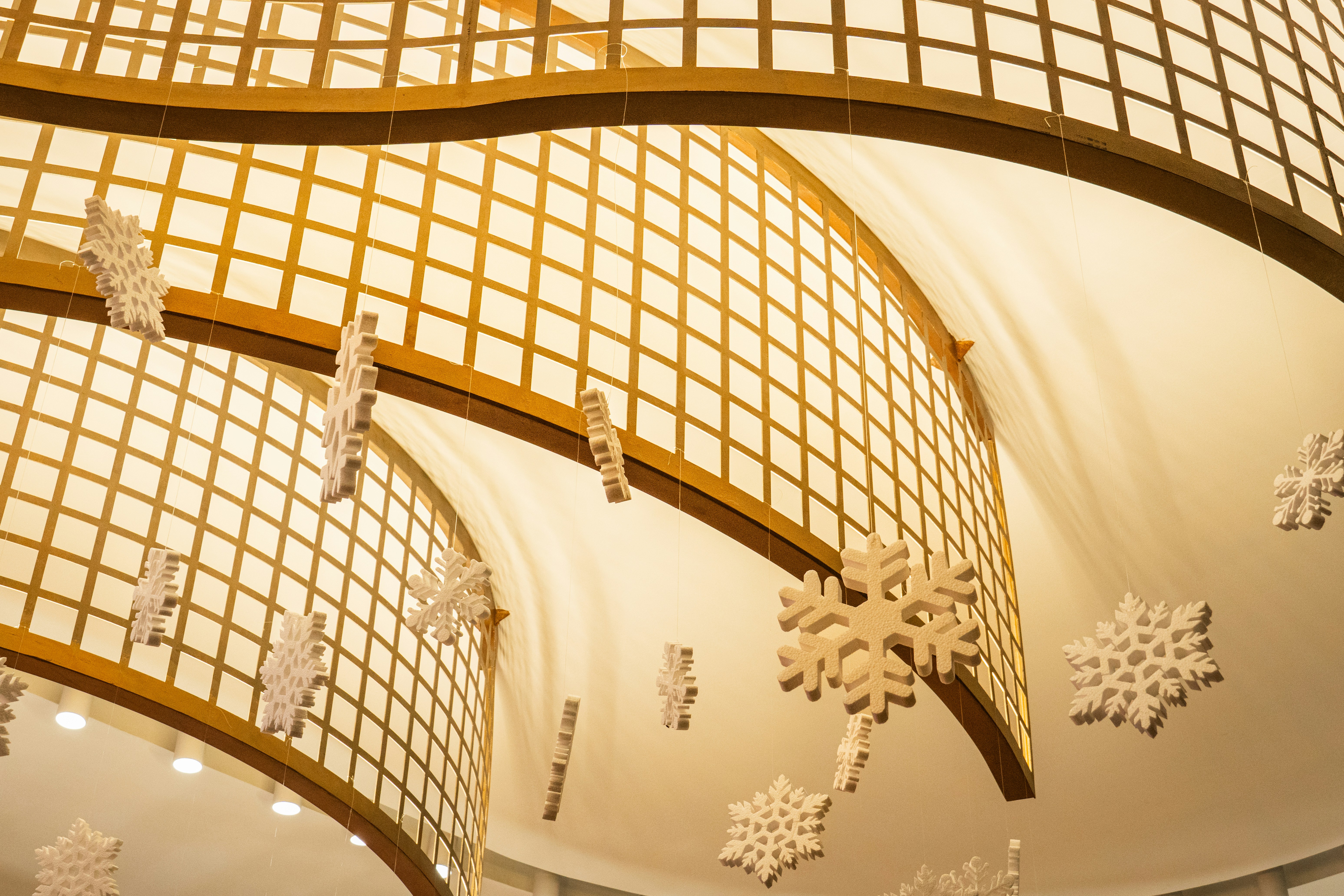 Snowflake decorations hanging from a ceiling