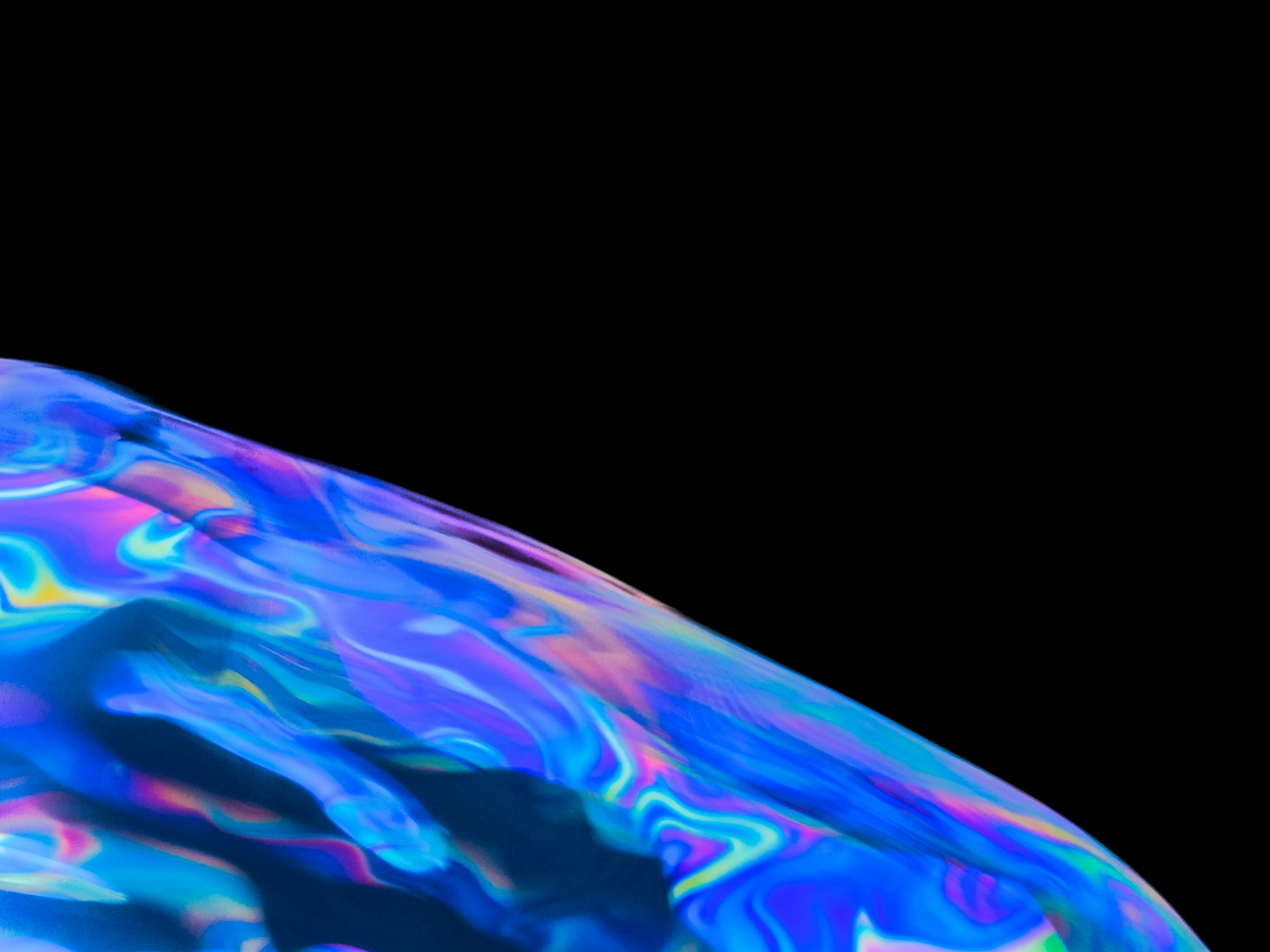 Abstract iridescent surface with vibrant blue, purple, and pink hues