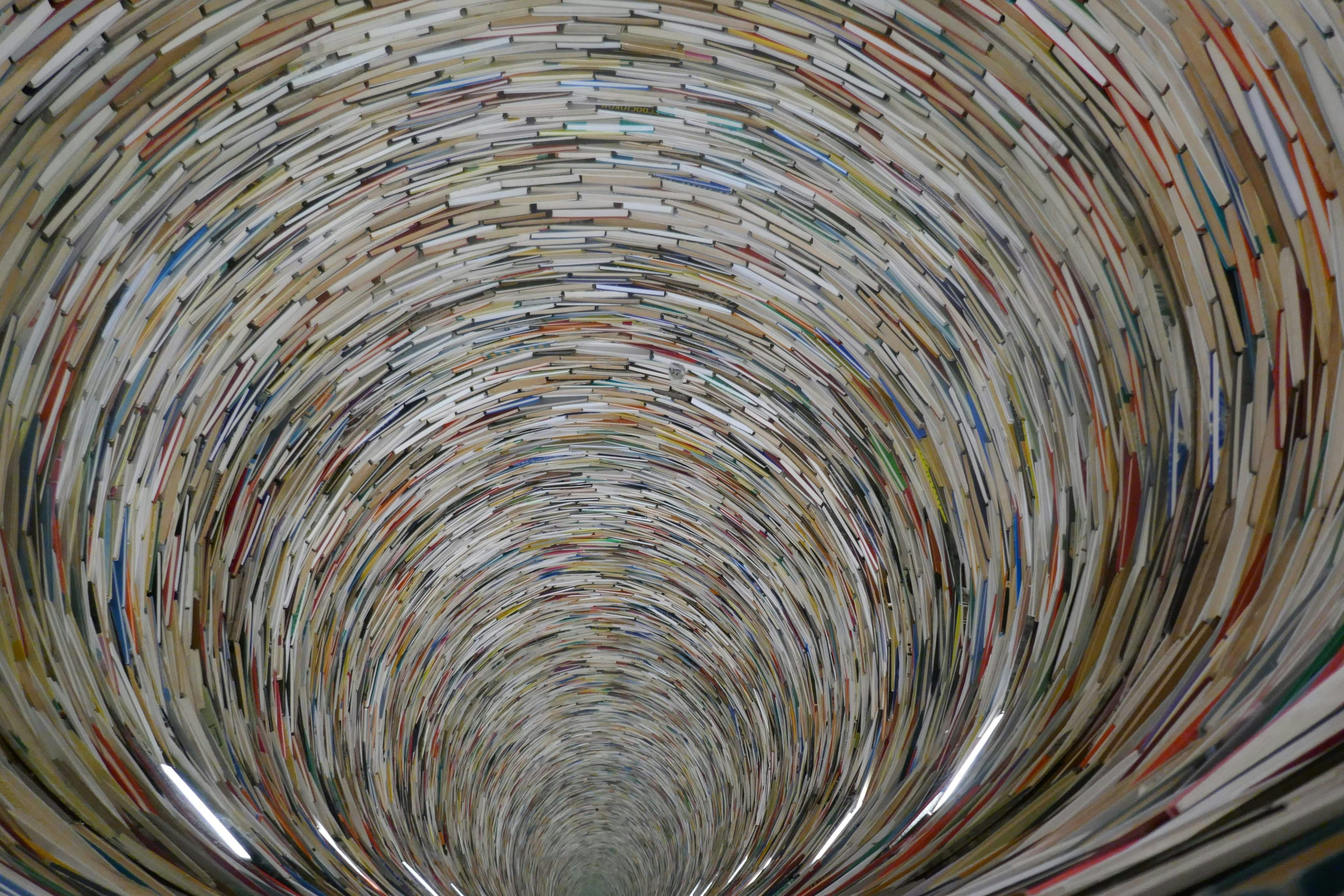 A tunnel made of stacked books receding into distance