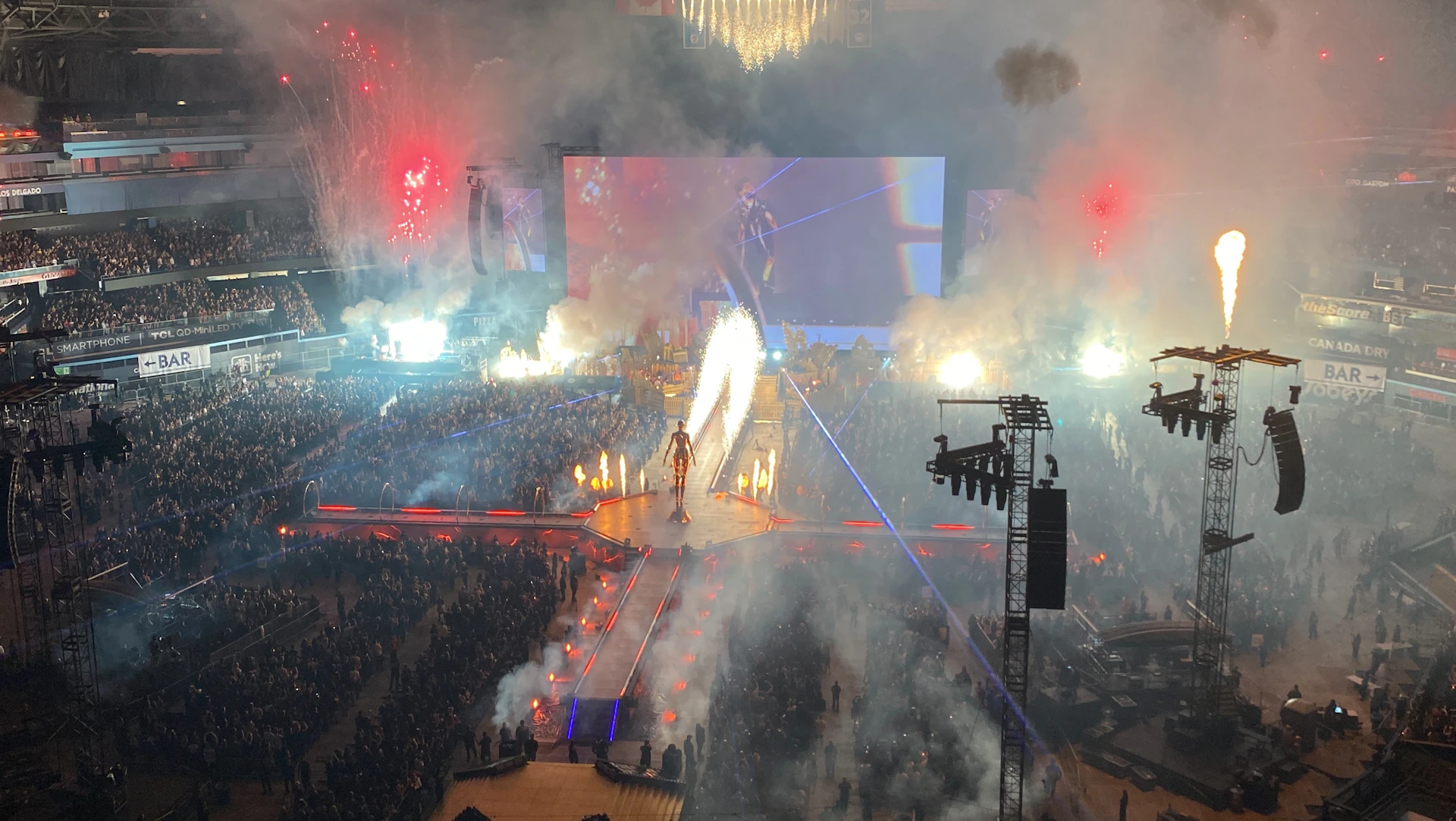 Concert stage with pyrotechnics and crowd at night