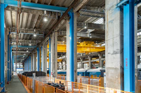 Industrial interior with blue beams and yellow crane
