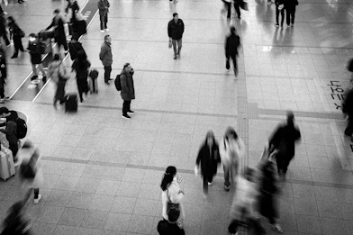 Blurred figures of people walking in a busy station