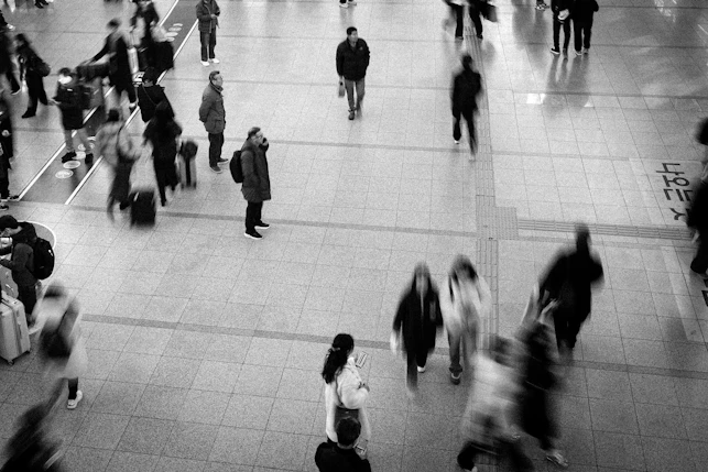 Blurred figures of people walking in a busy station
