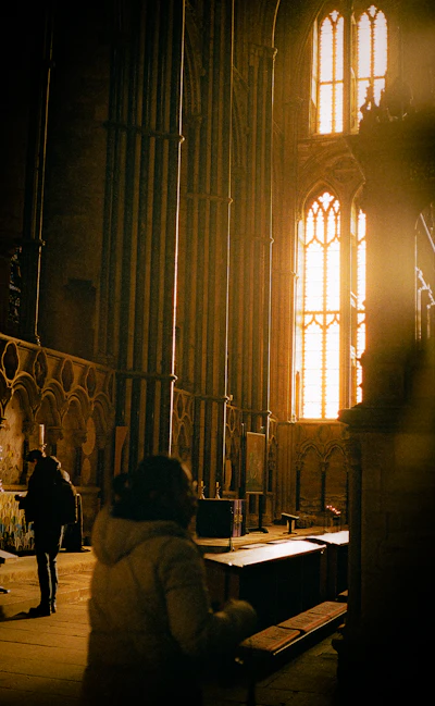 Sunlight through cathedral windows onto worshippers