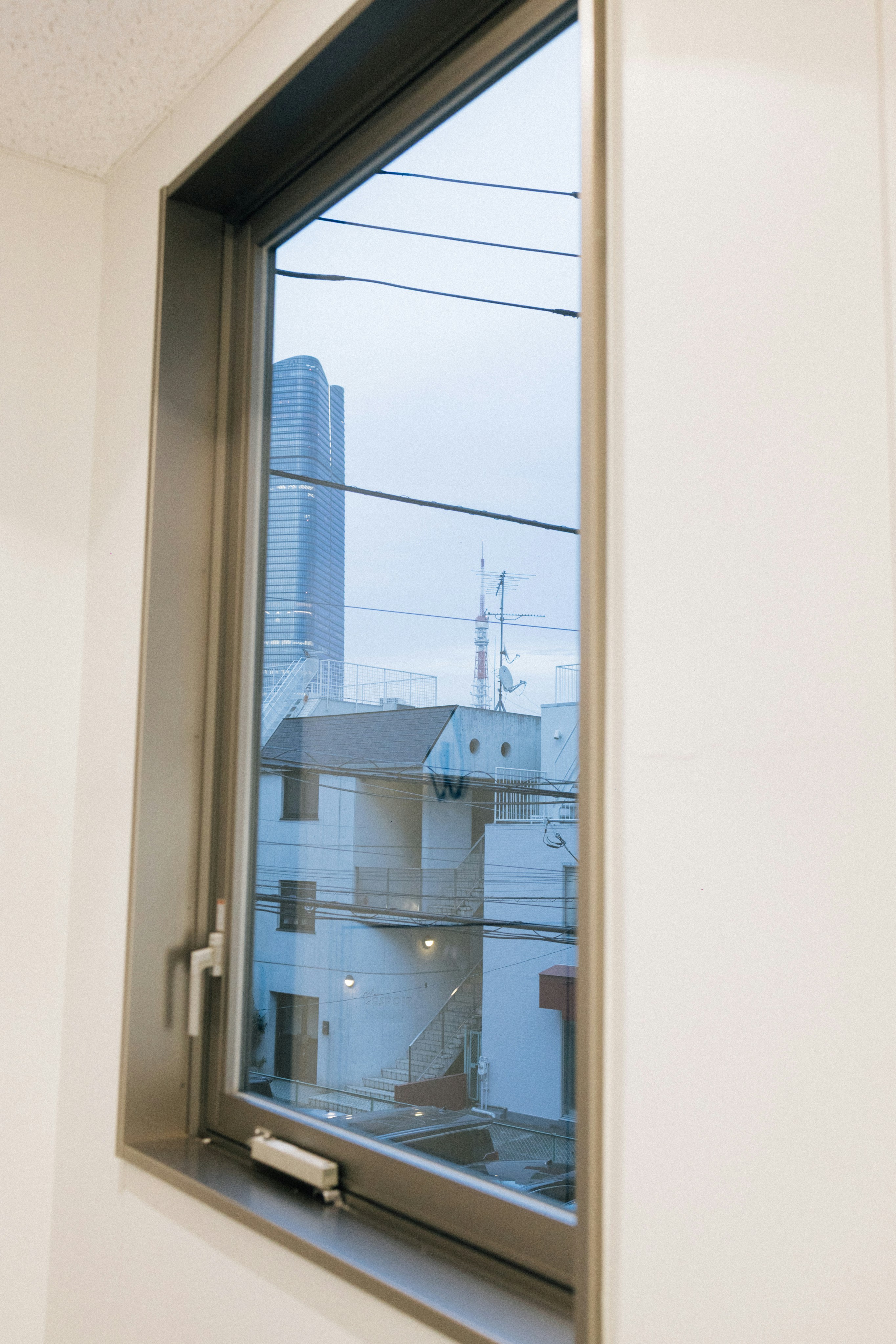 View of city buildings through a window photo – Free Cityscape Image on ...
