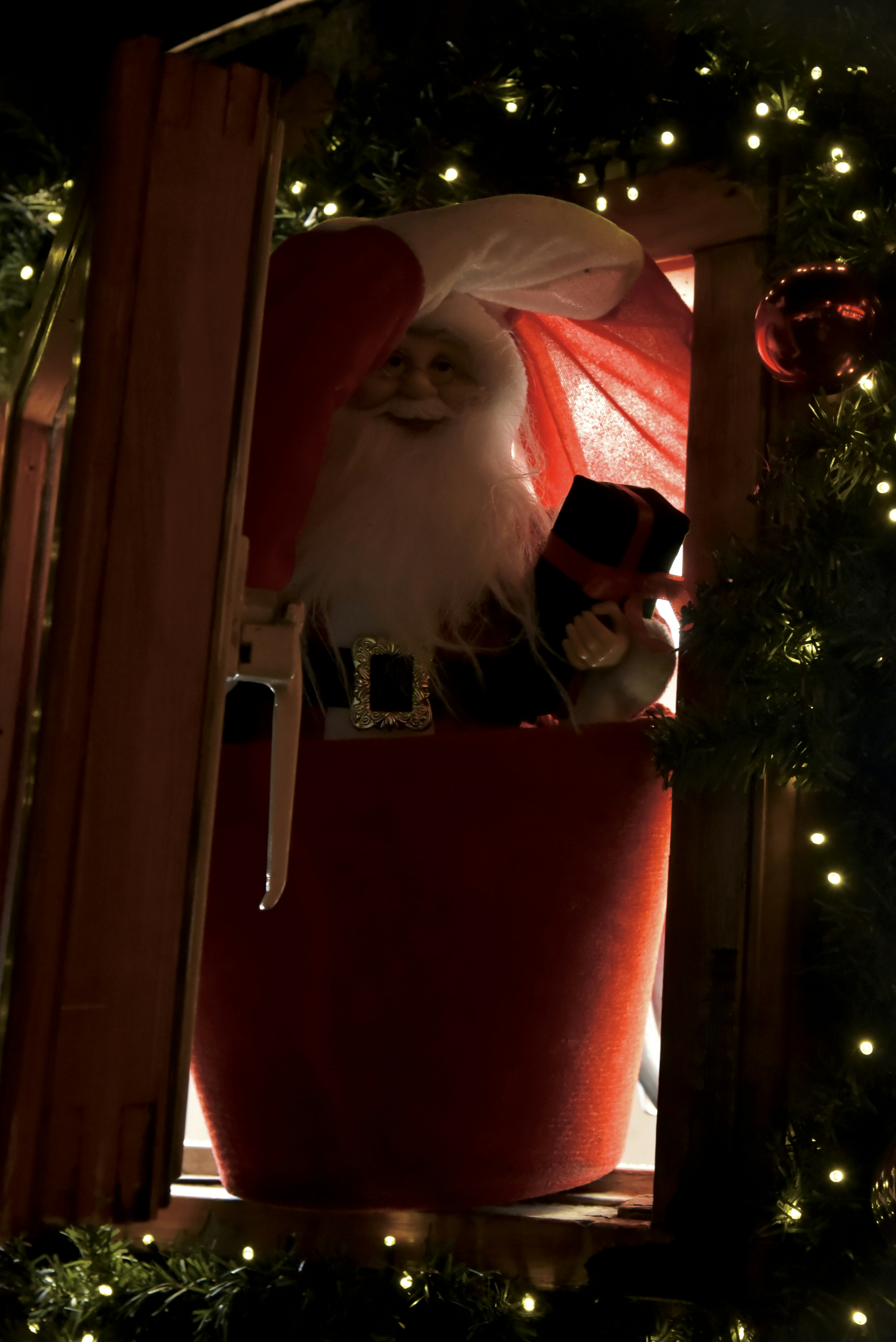 Santa claus in a red sack with a gift.