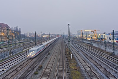A fast train speeds down multiple tracks.