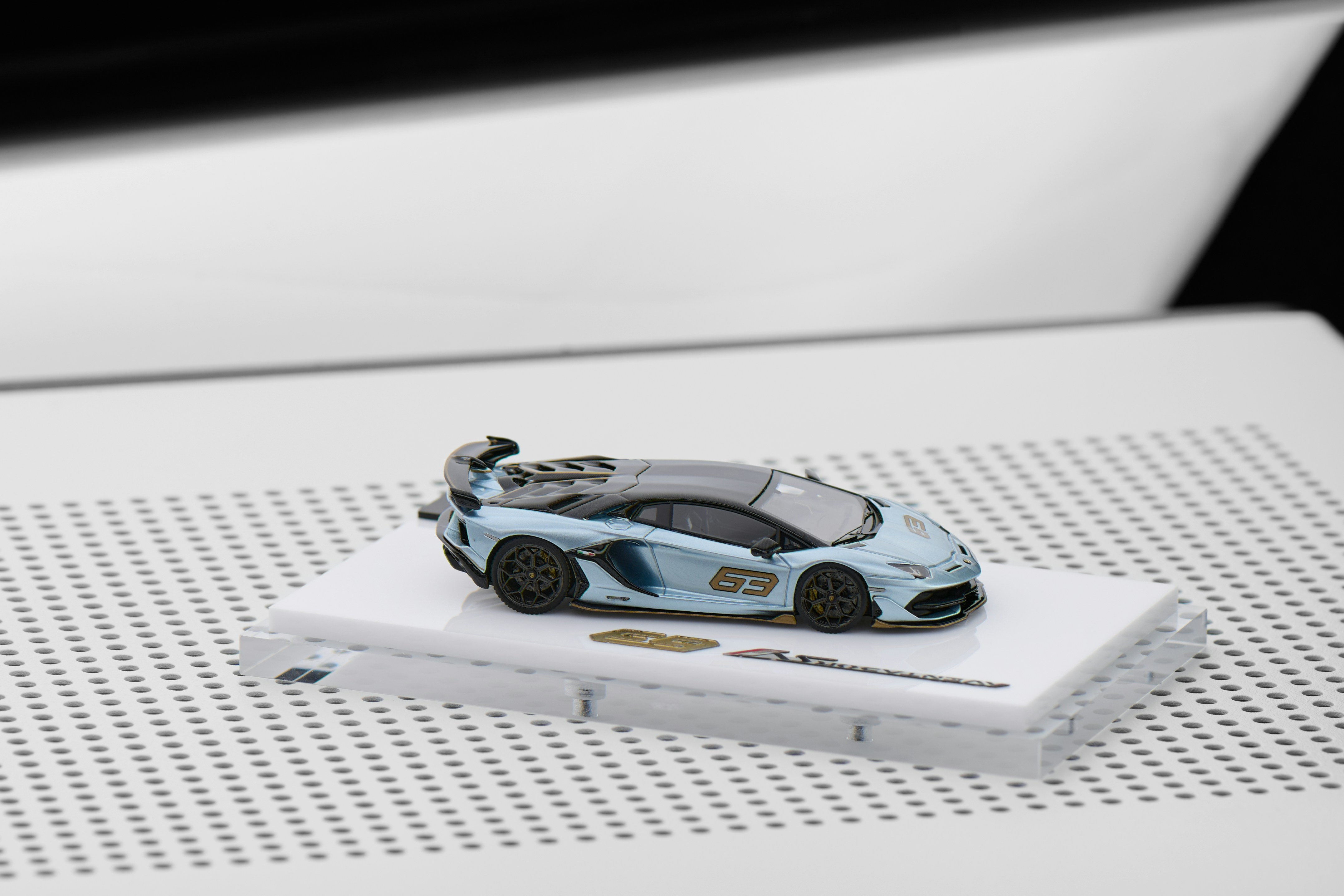A light blue toy sports car with racing decals.