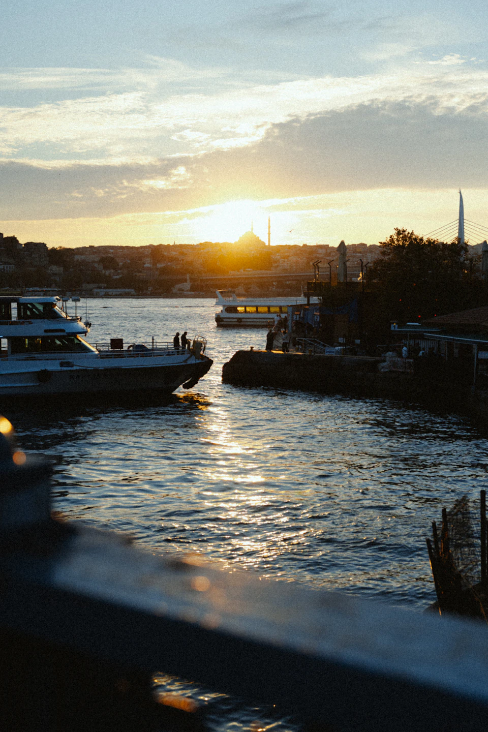 Serene harbor at sunset with boats docked along the shoreline amidst warm orange hues