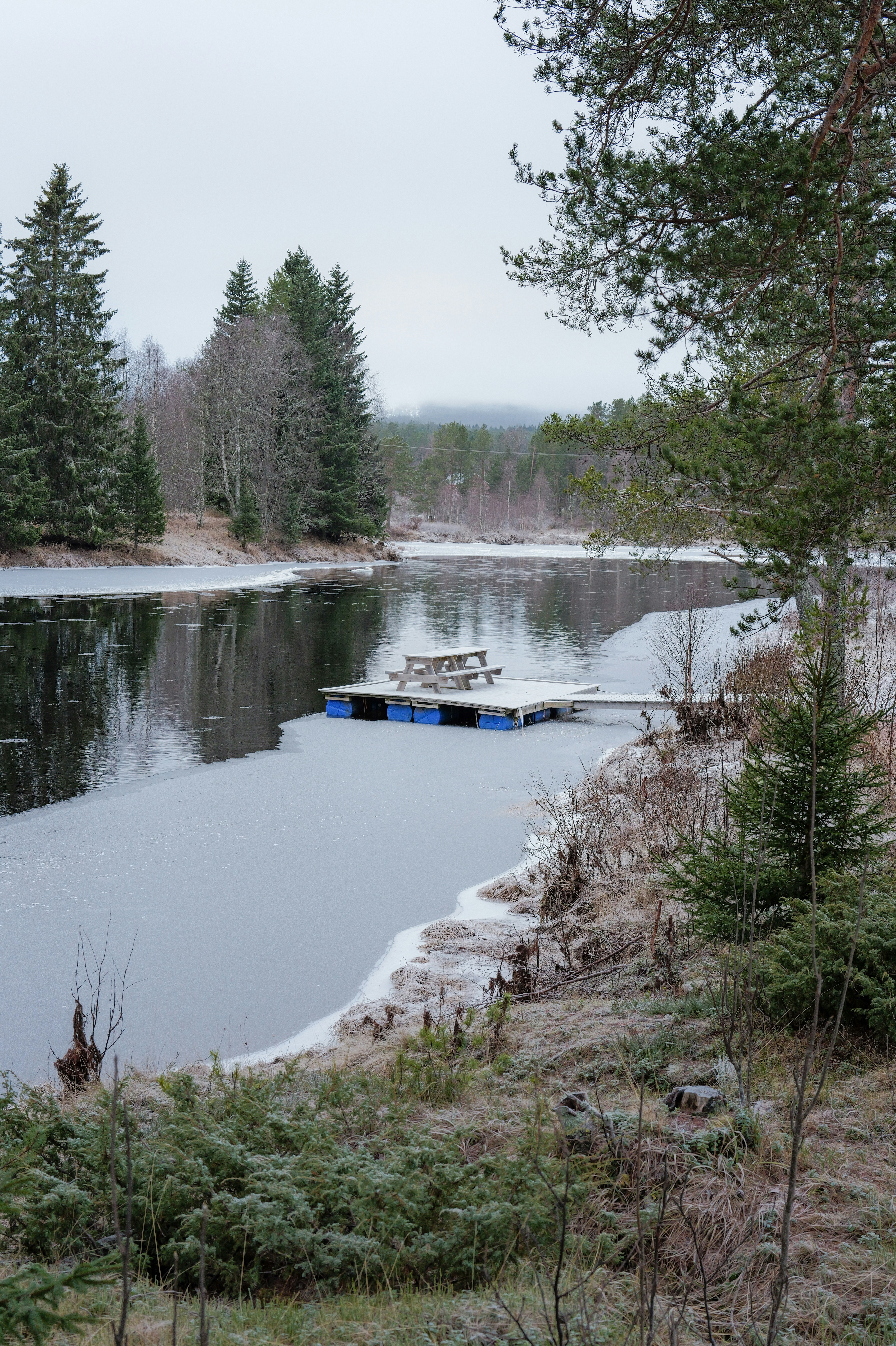 Floating dock with picnic table on frozen lake