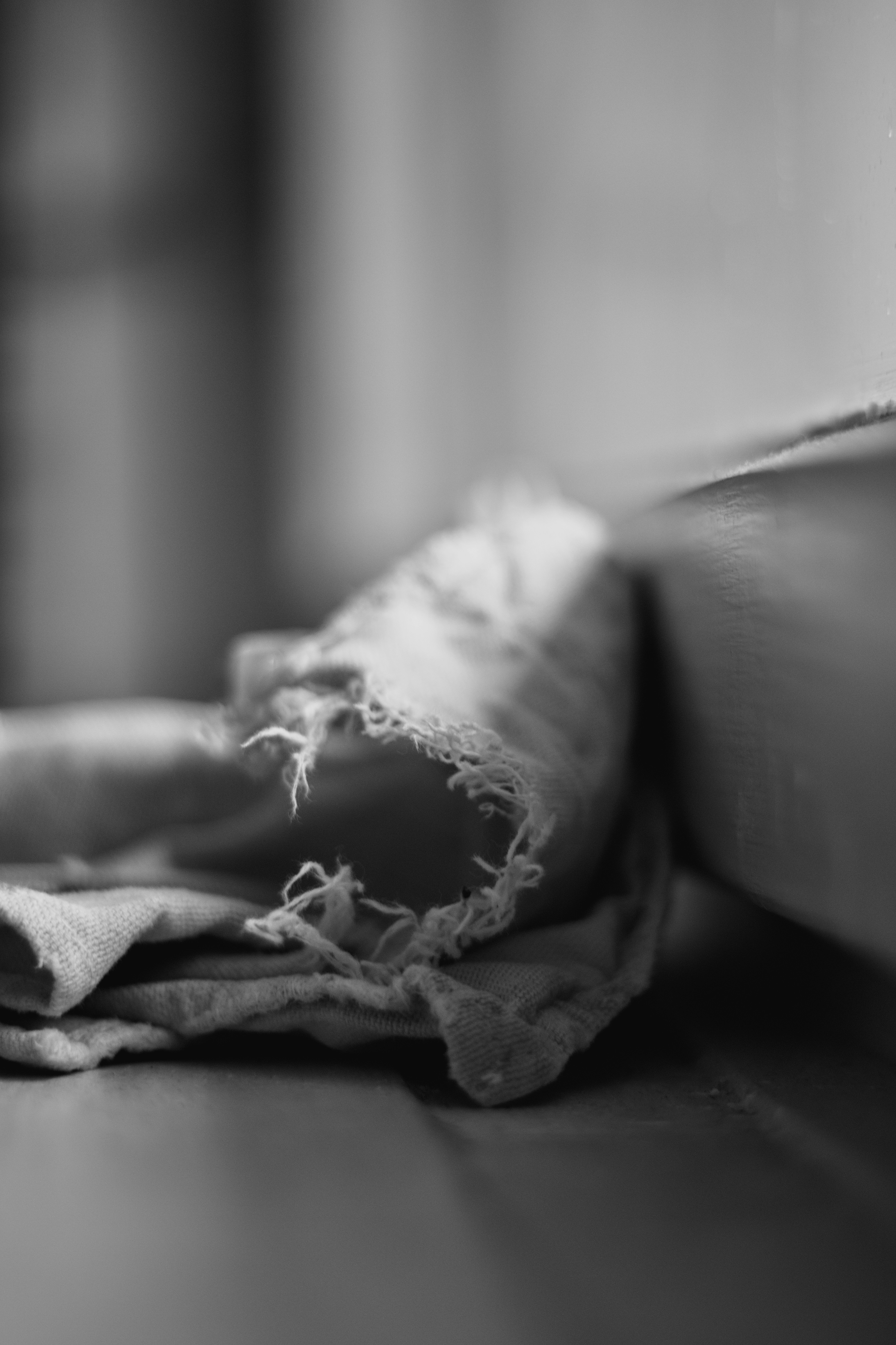 A close-up black and white of a worn cloth