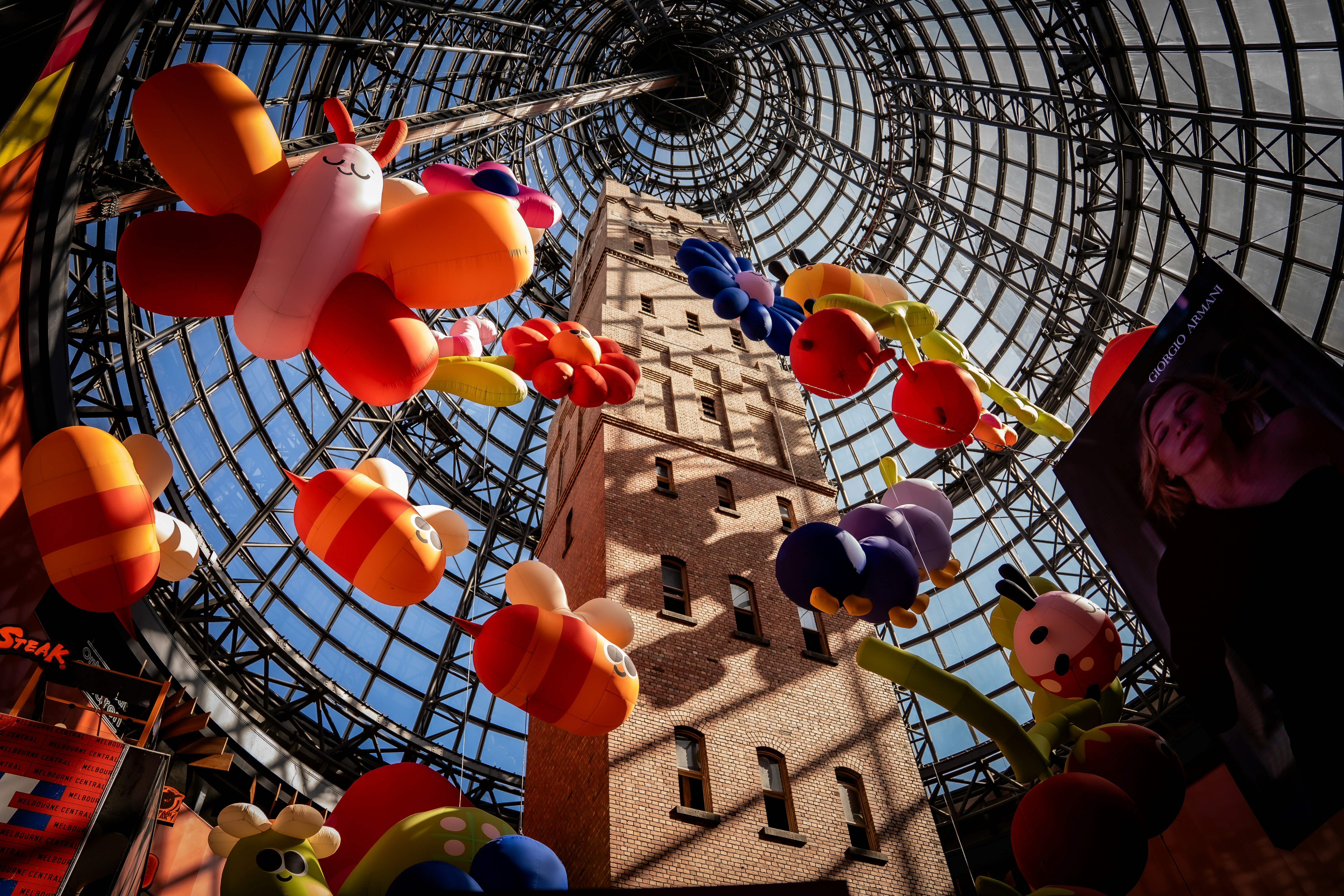 Colorful balloon animals and decorations hanging indoors.