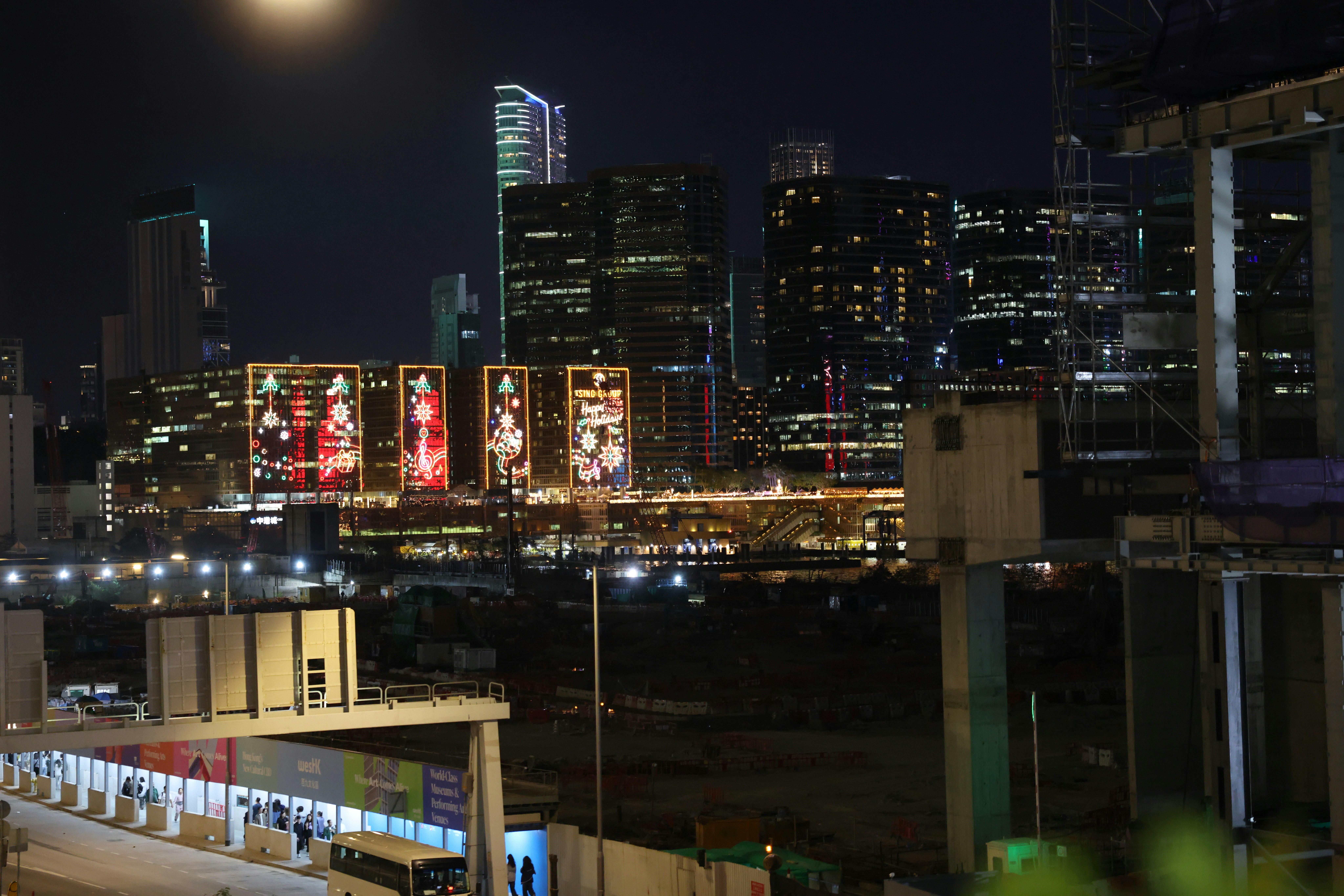 City skyline with illuminated buildings at night.
