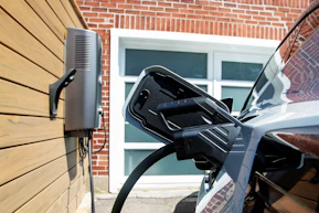 Electric car charging station on a wooden wall