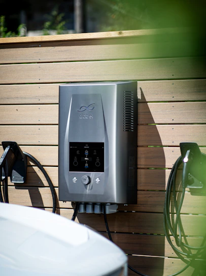 Electric car charger mounted on wooden wall