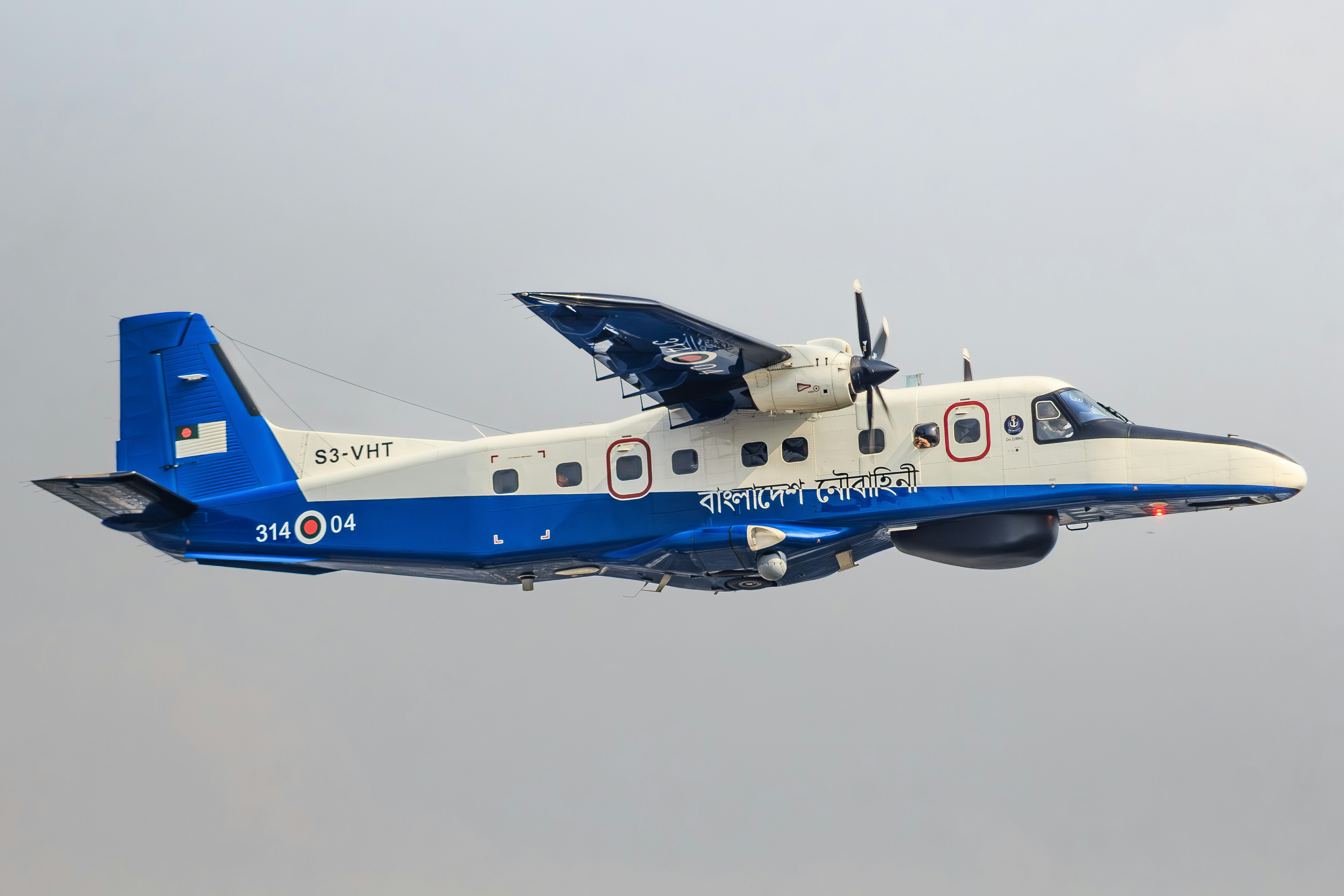 A twin-engine turboprop aircraft flying in the sky.