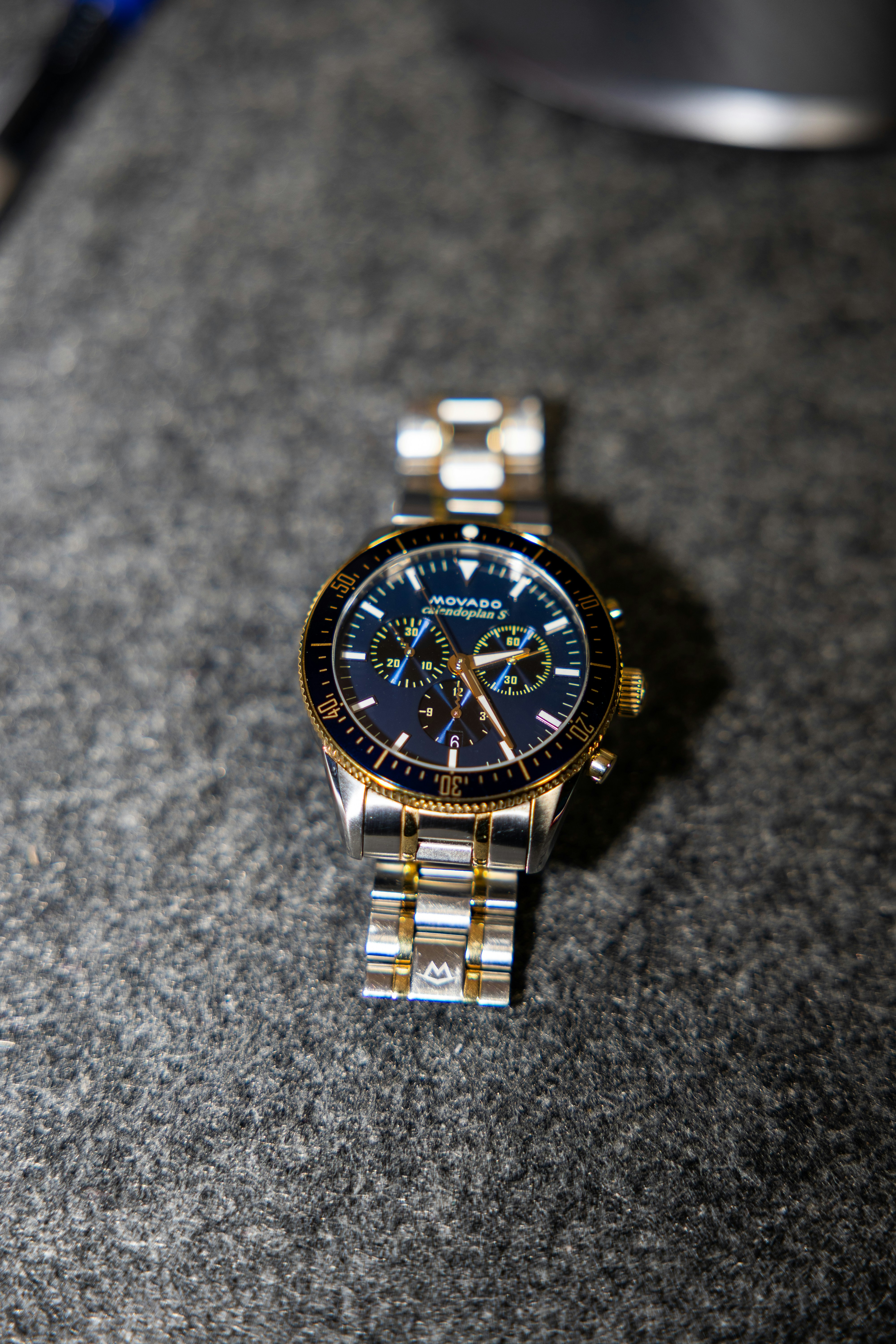 A close-up of a gold and silver watch