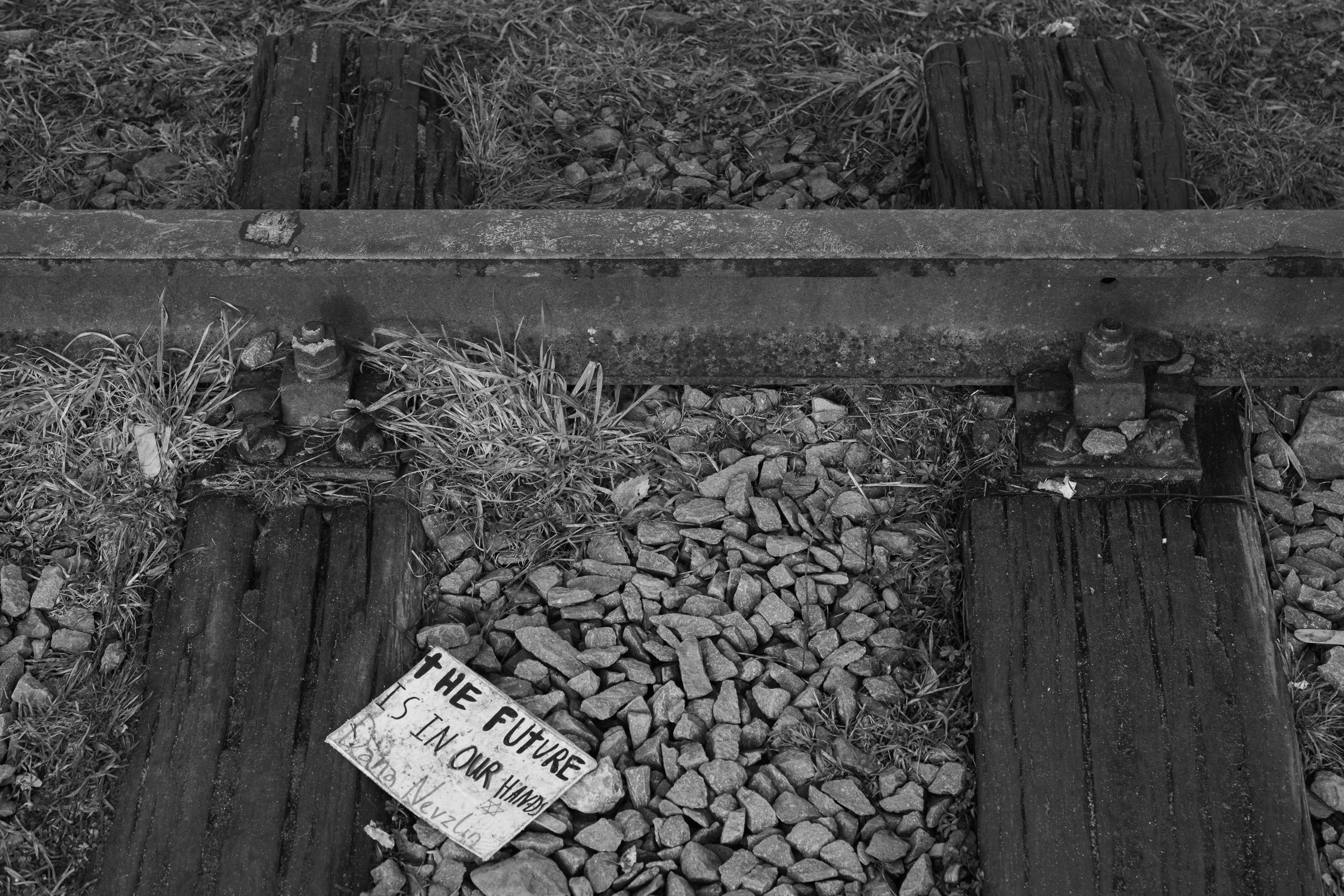 Sign on railroad tracks reads 'the future is our own'
