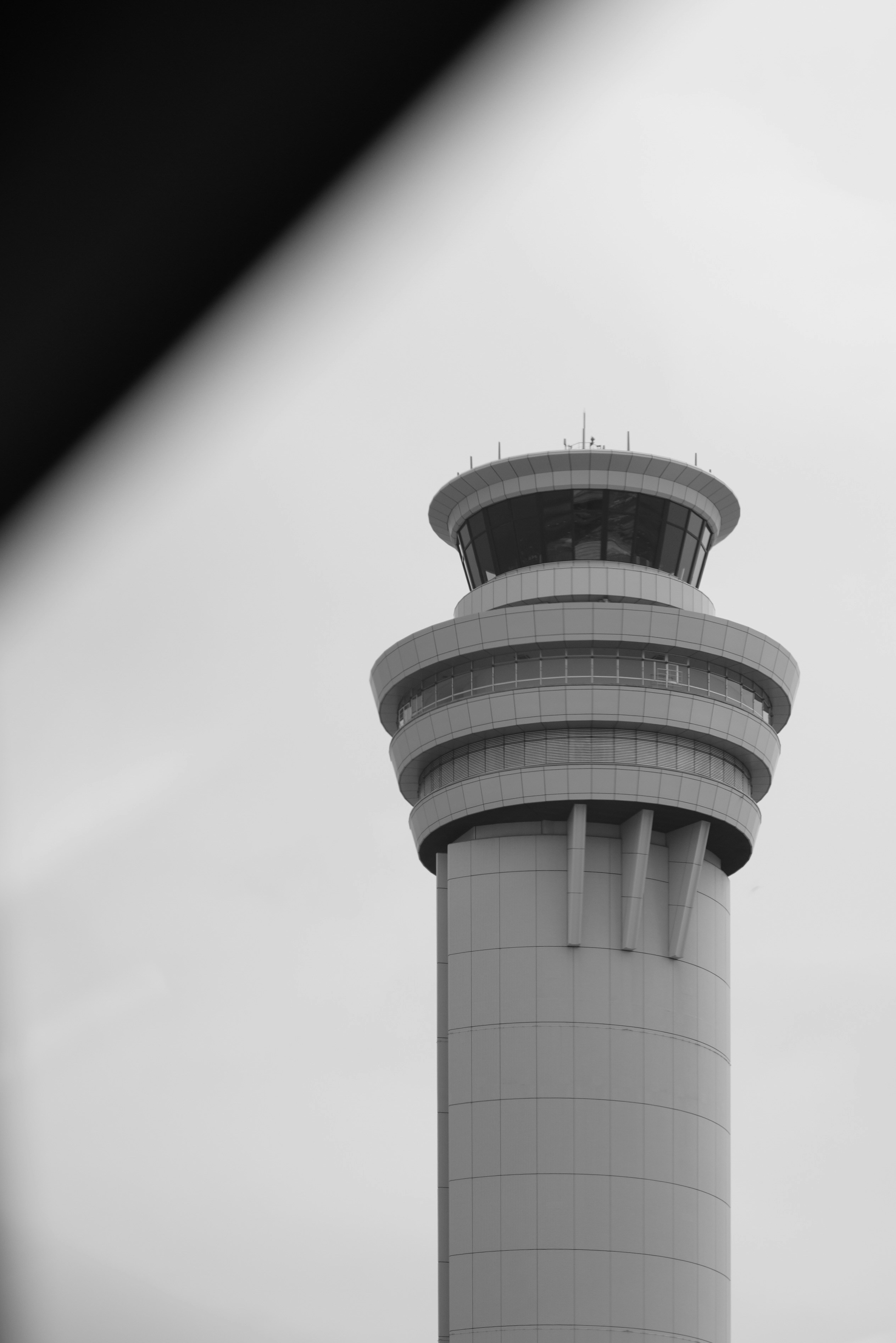 Control tower at an airport under a cloudy sky