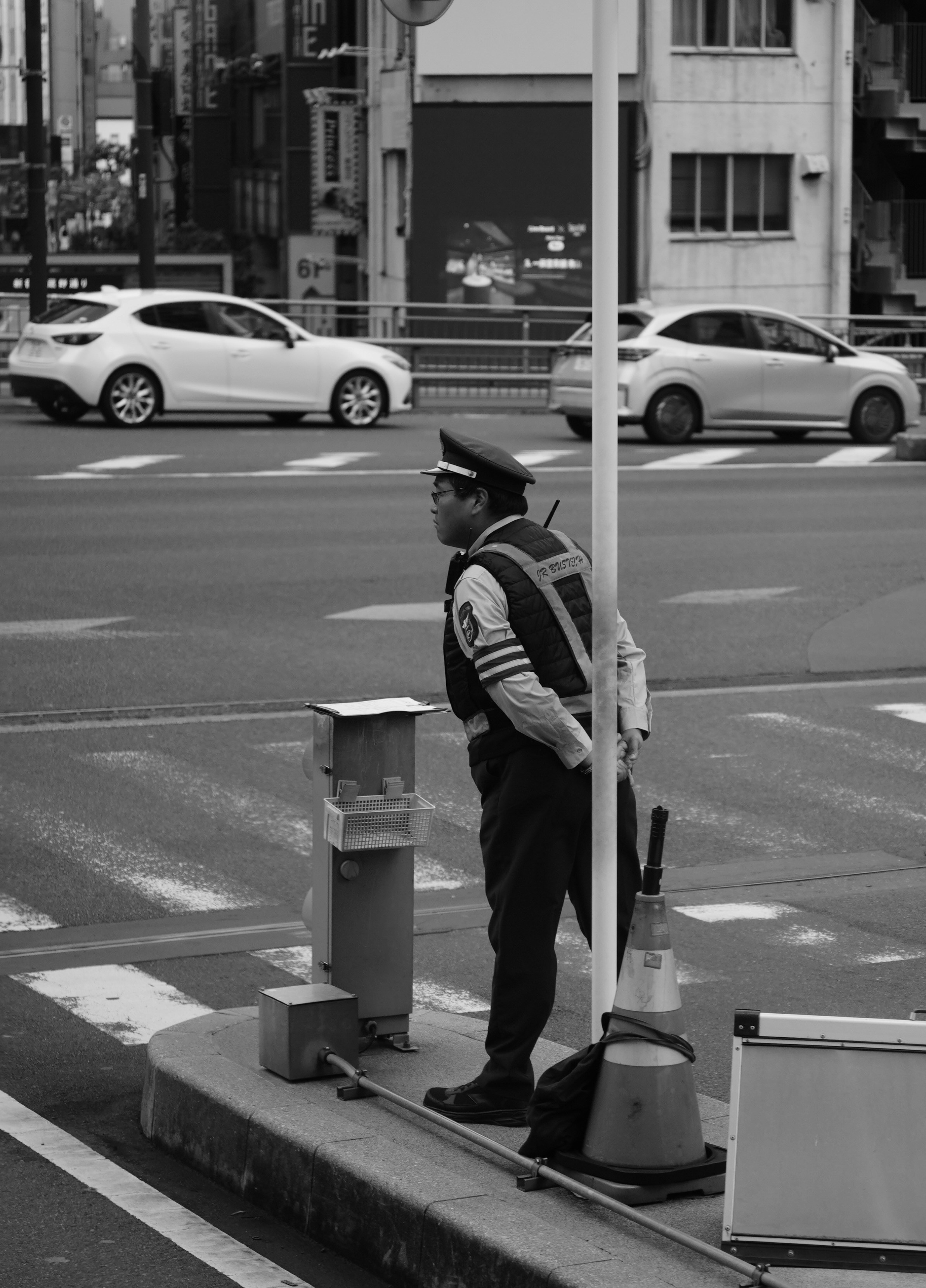 Traffic controller directing traffic on a city street.