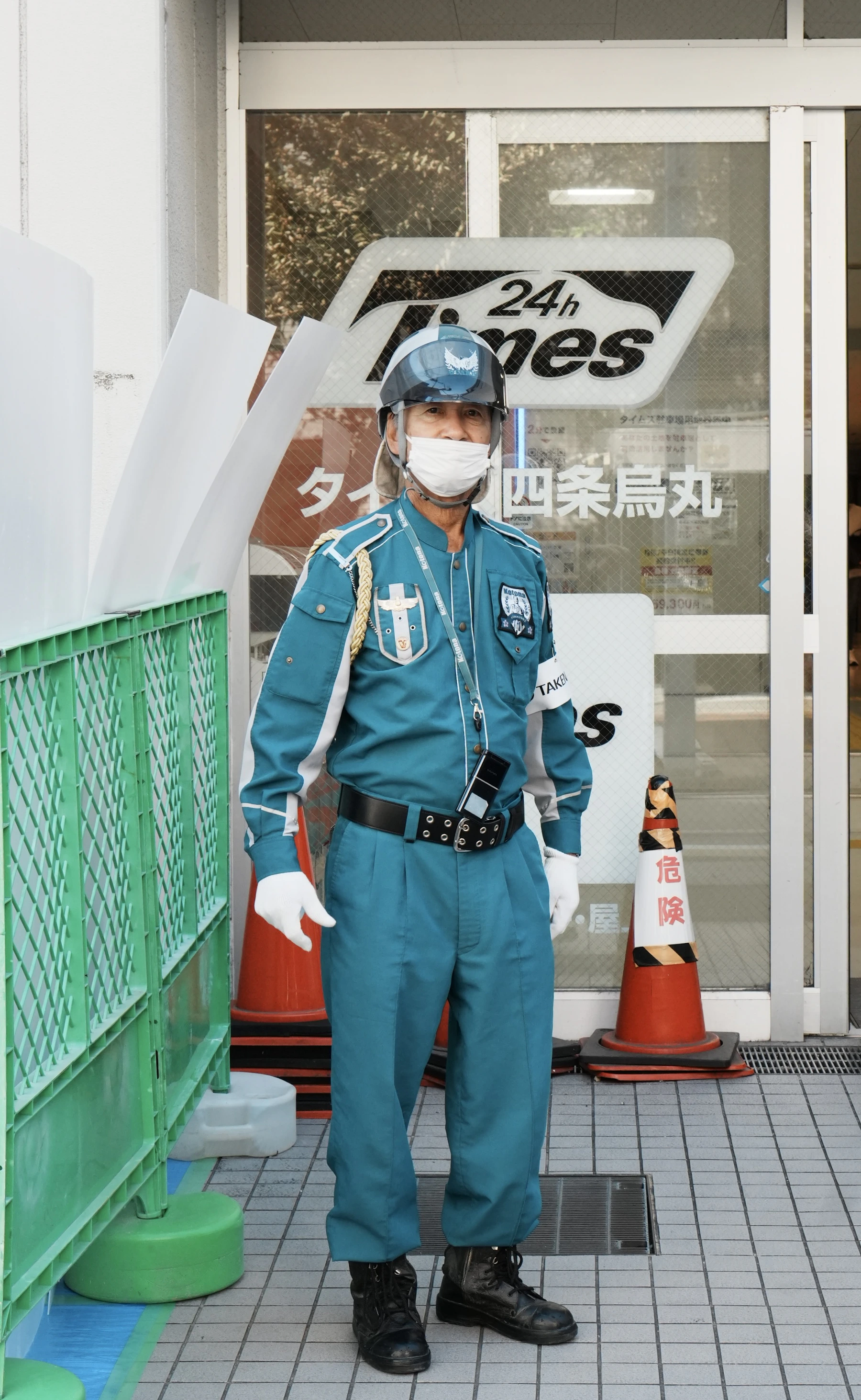 Uniformed security guard standing outside a commercial storefront