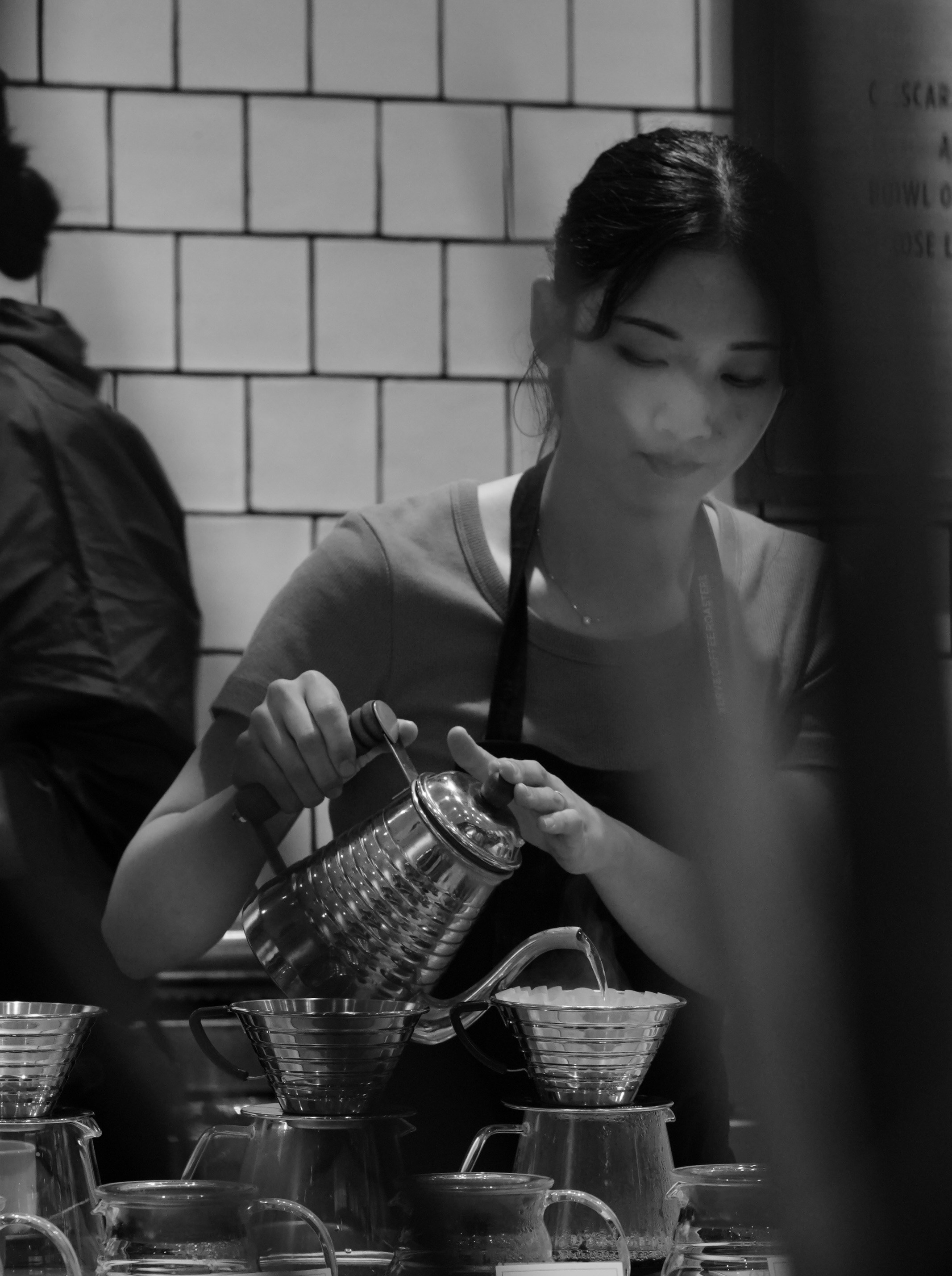 Barista pouring water into coffee filter