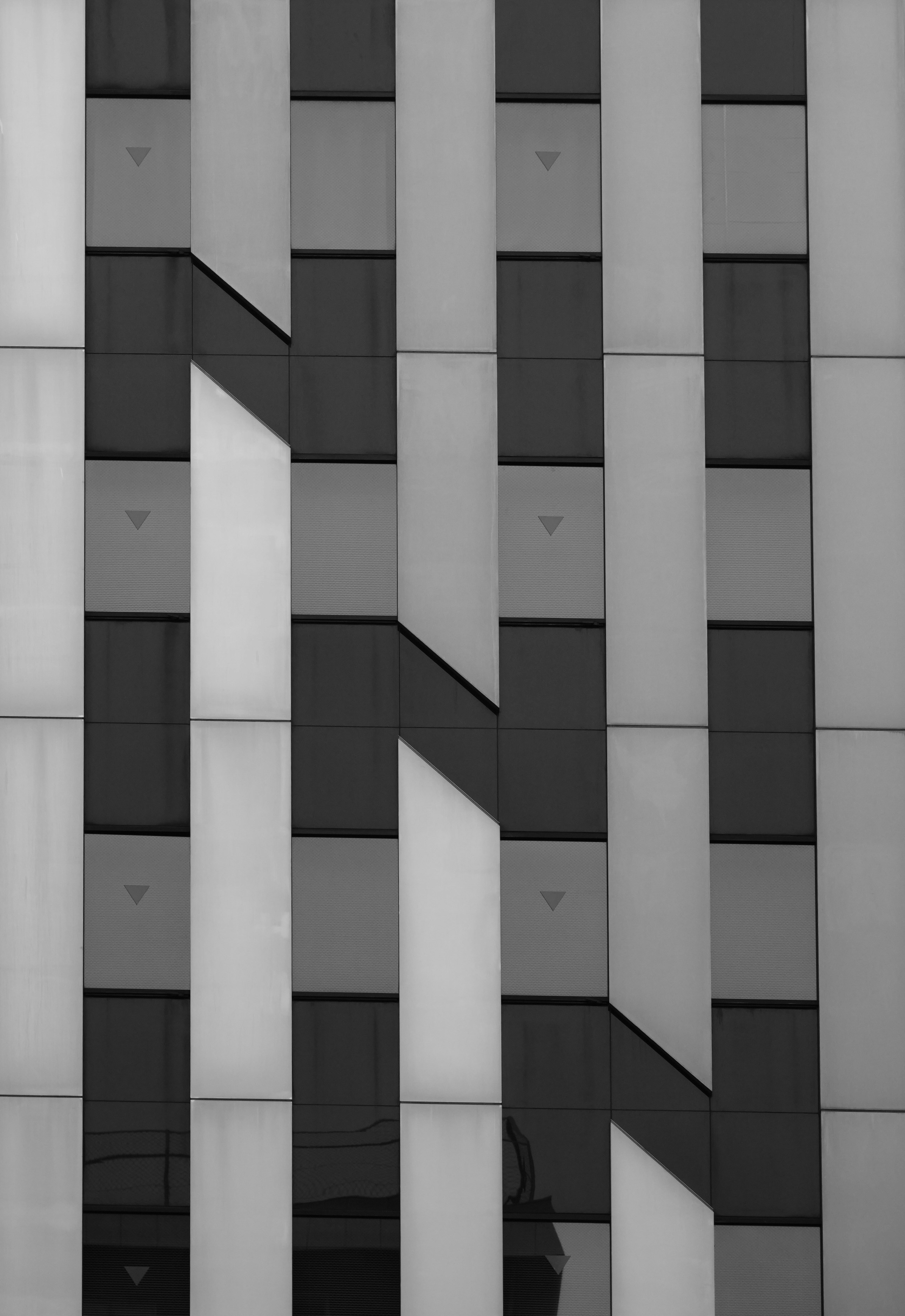 Modern building facade with geometric patterns and shadow