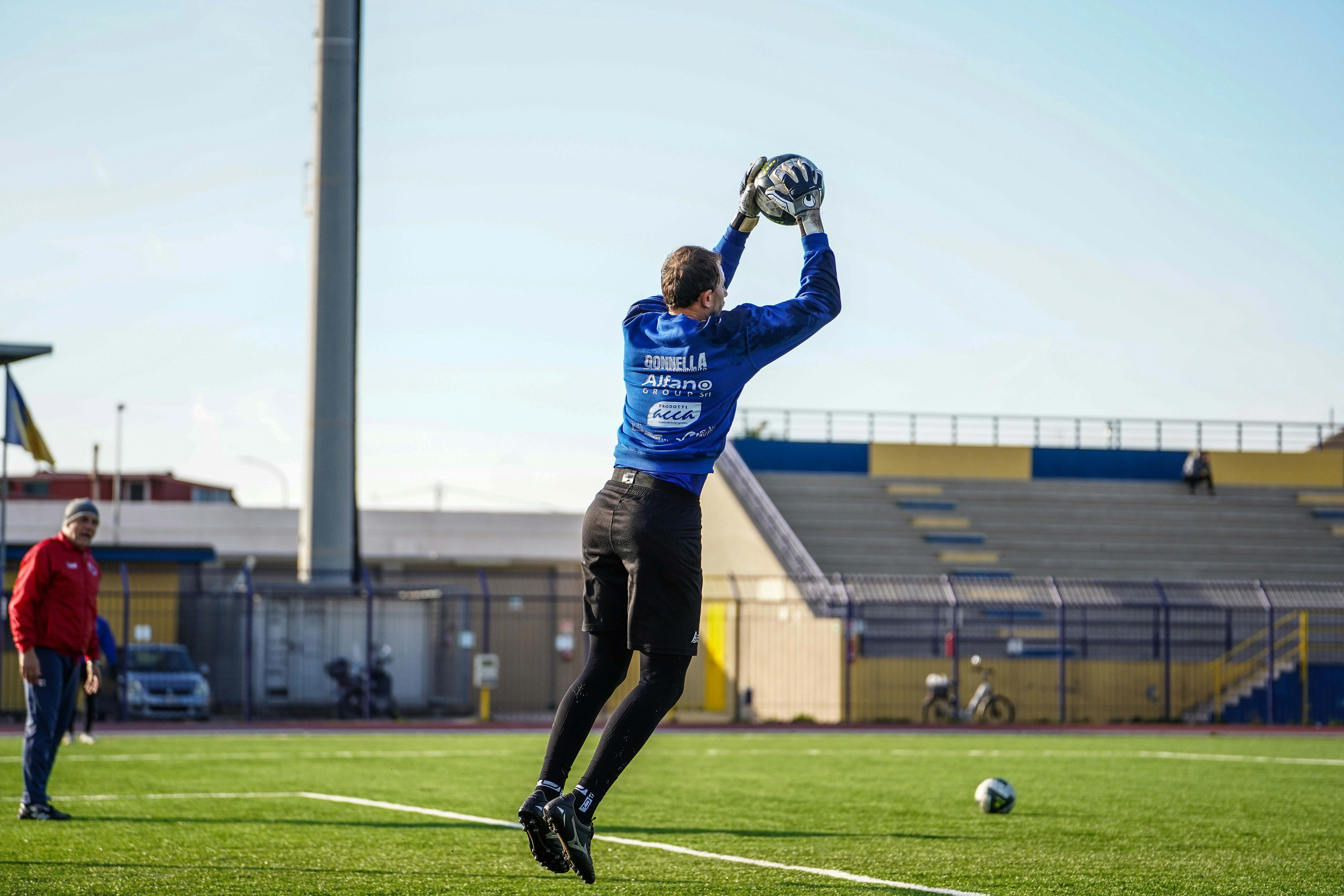 Goalkeeper catching a soccer ball during a game