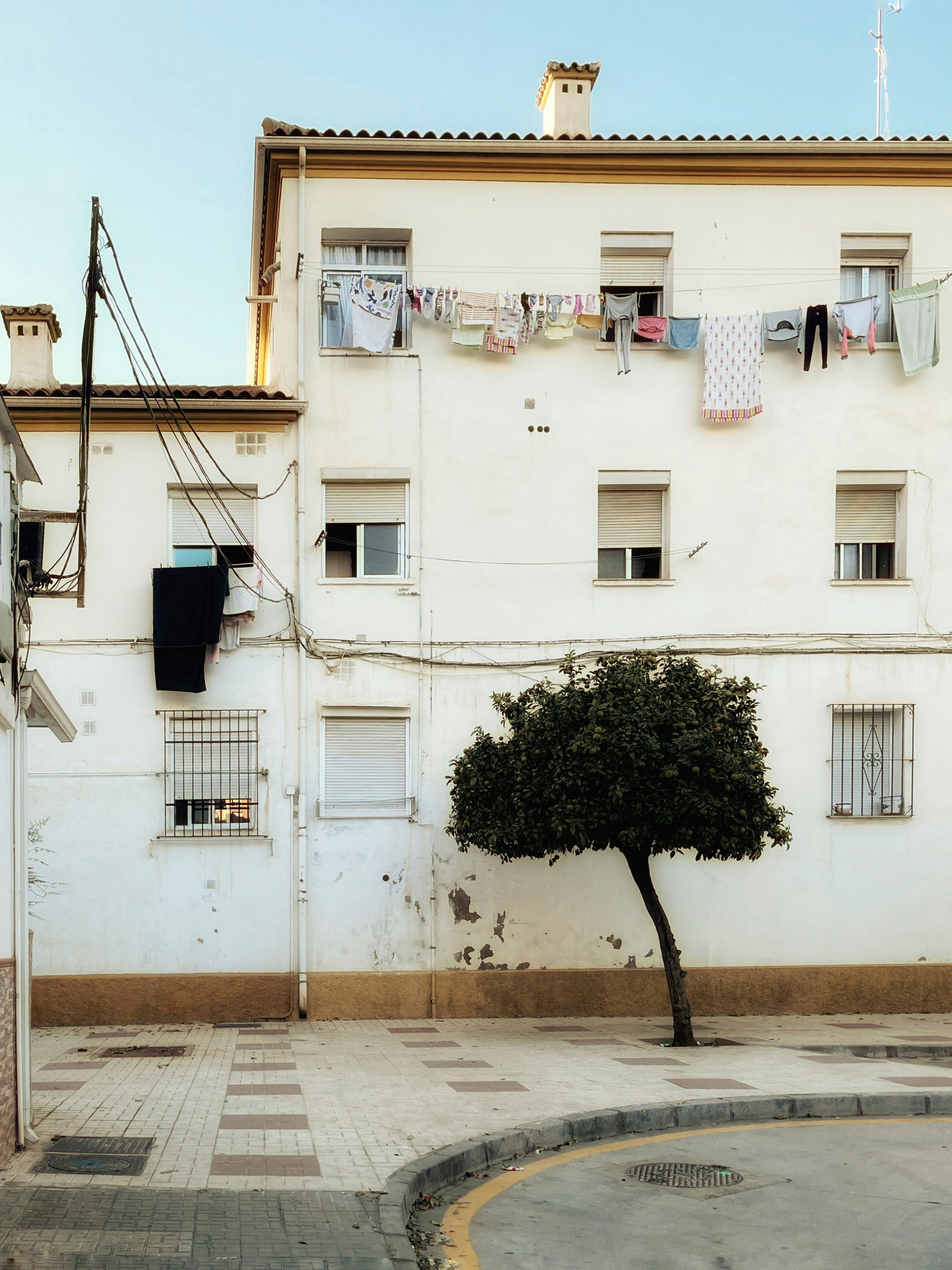 White building with clothes drying on lines
