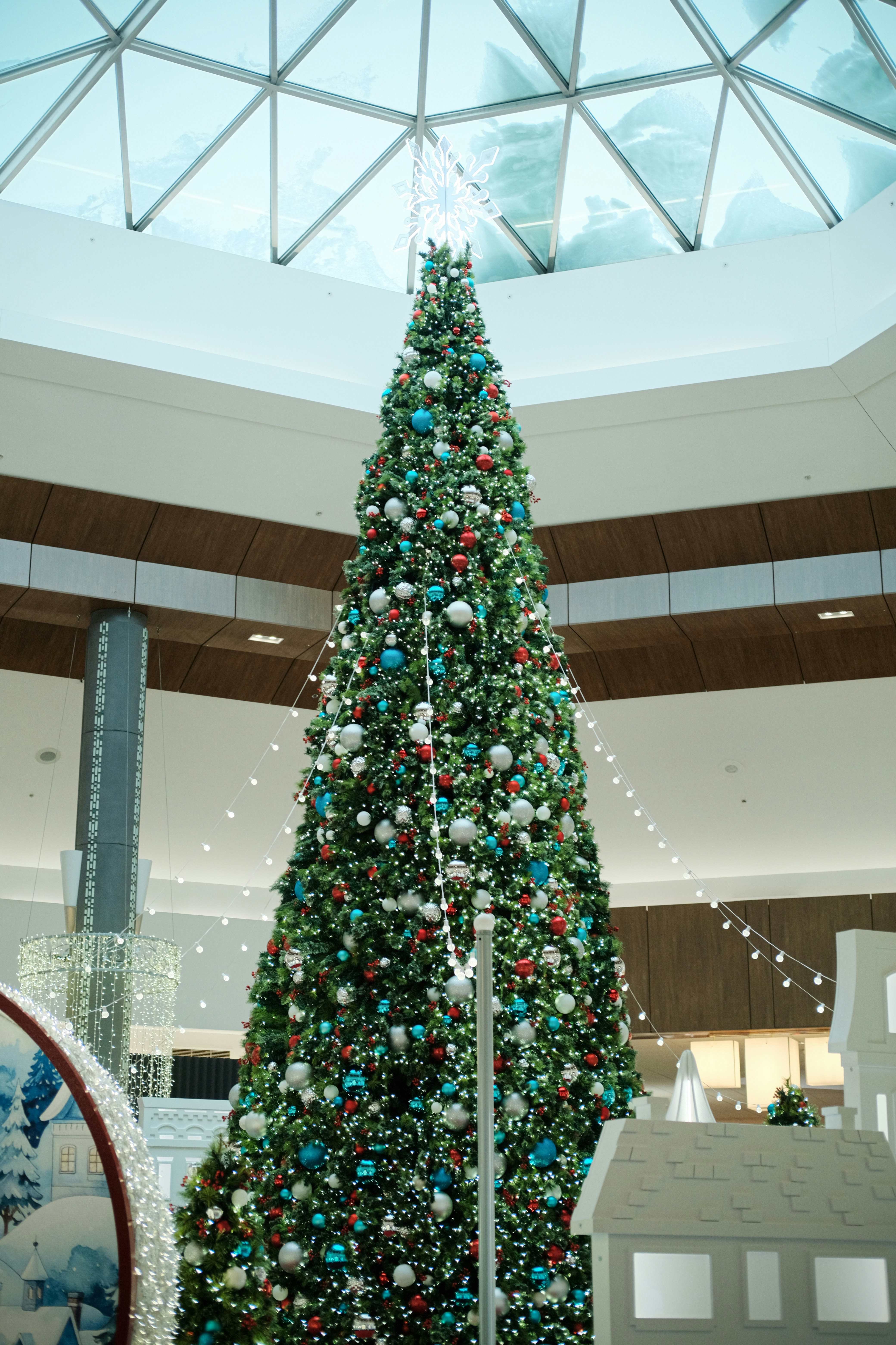 Large decorated christmas tree inside a shopping mall.
