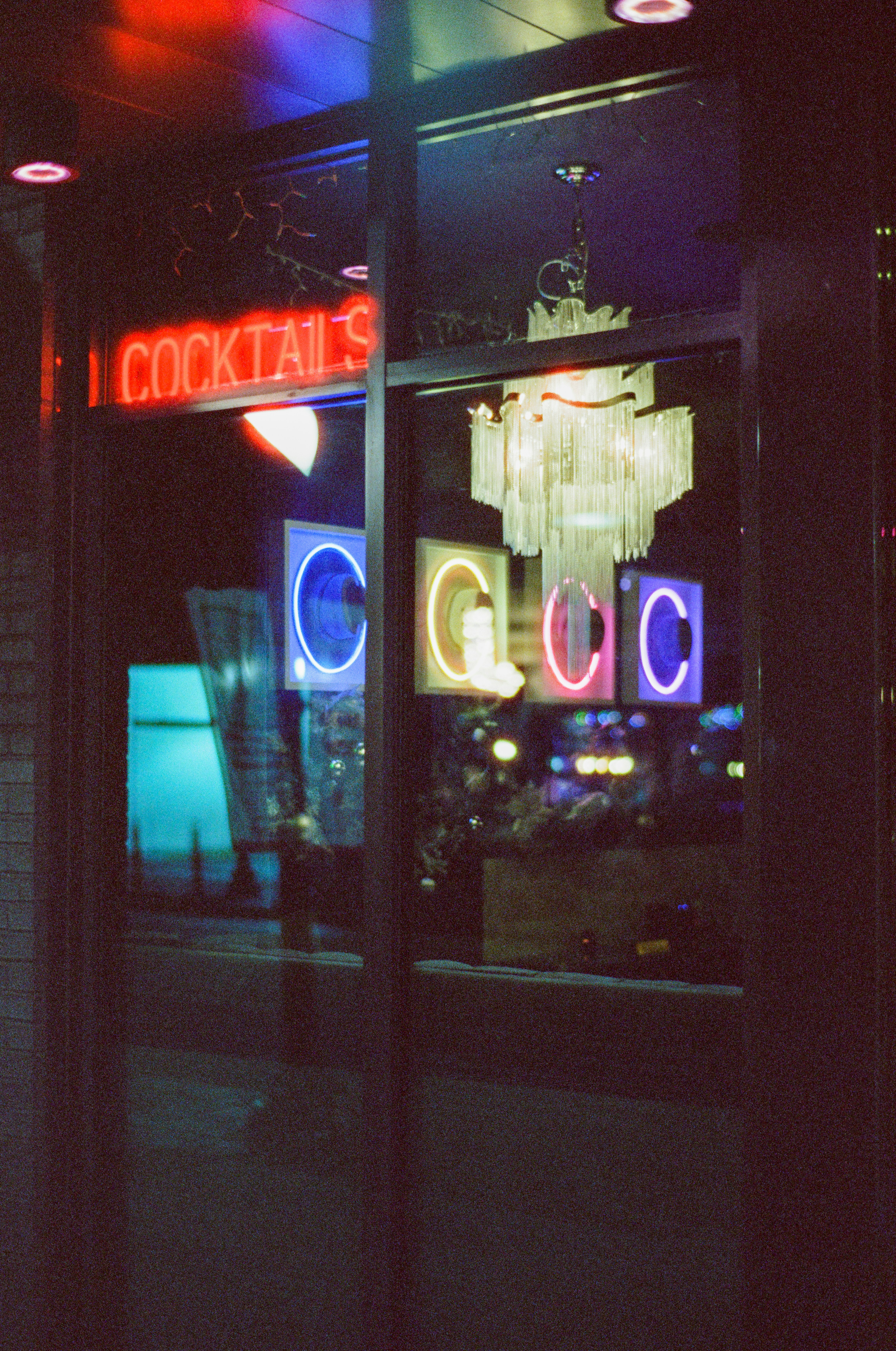 Neon sign for cocktails above a bar window