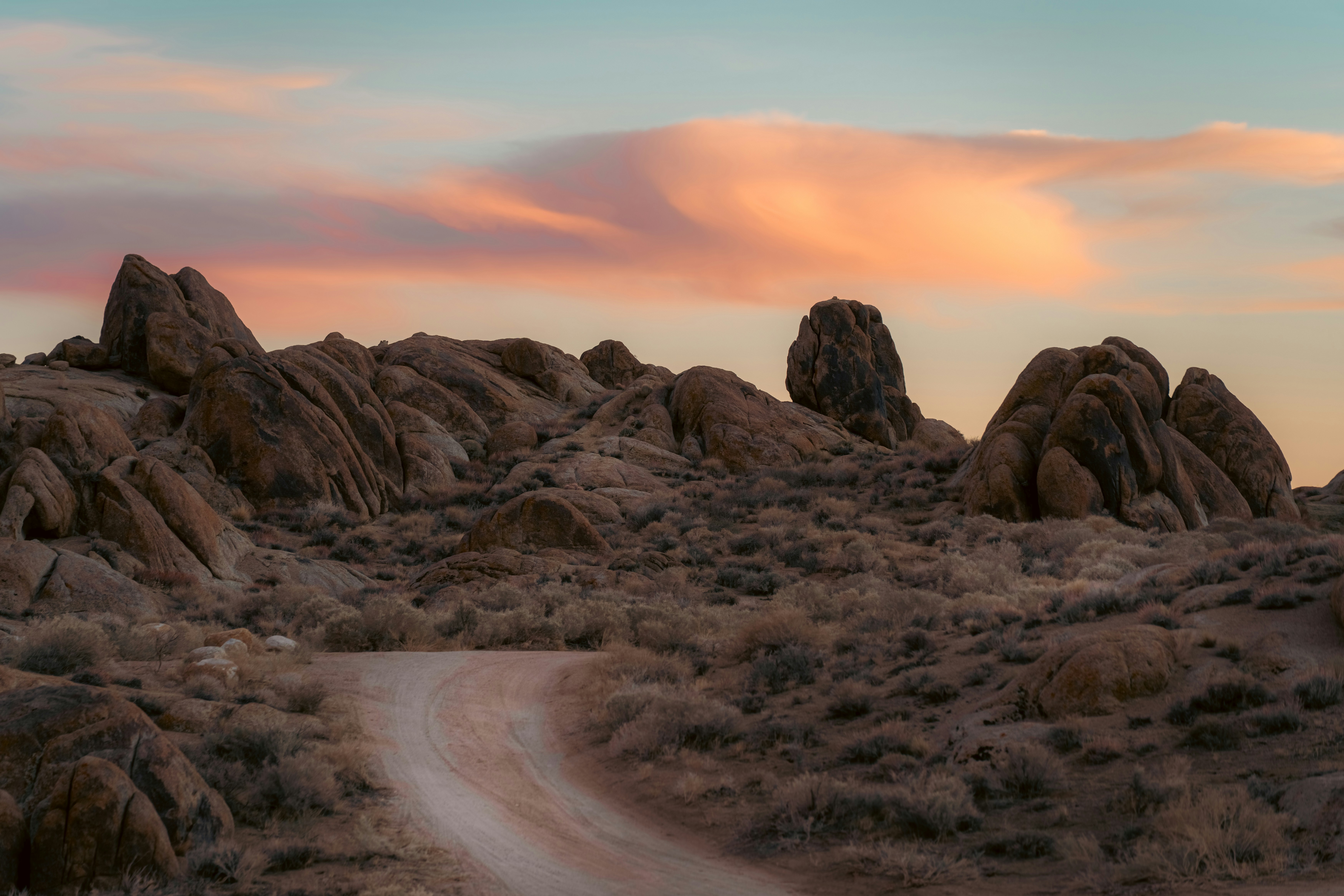 Desert landscape with rocky formations and sunset sky