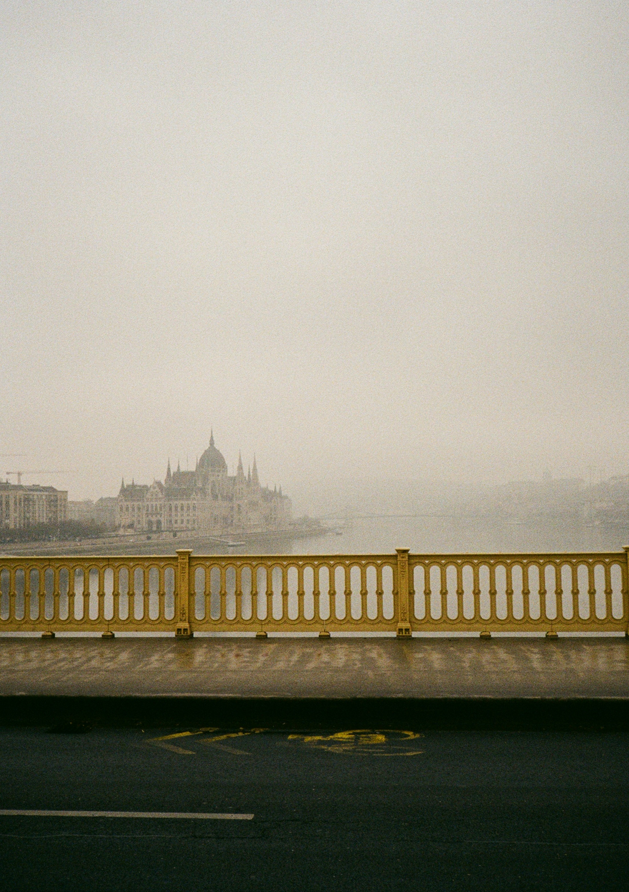A foggy view of a city across a river.