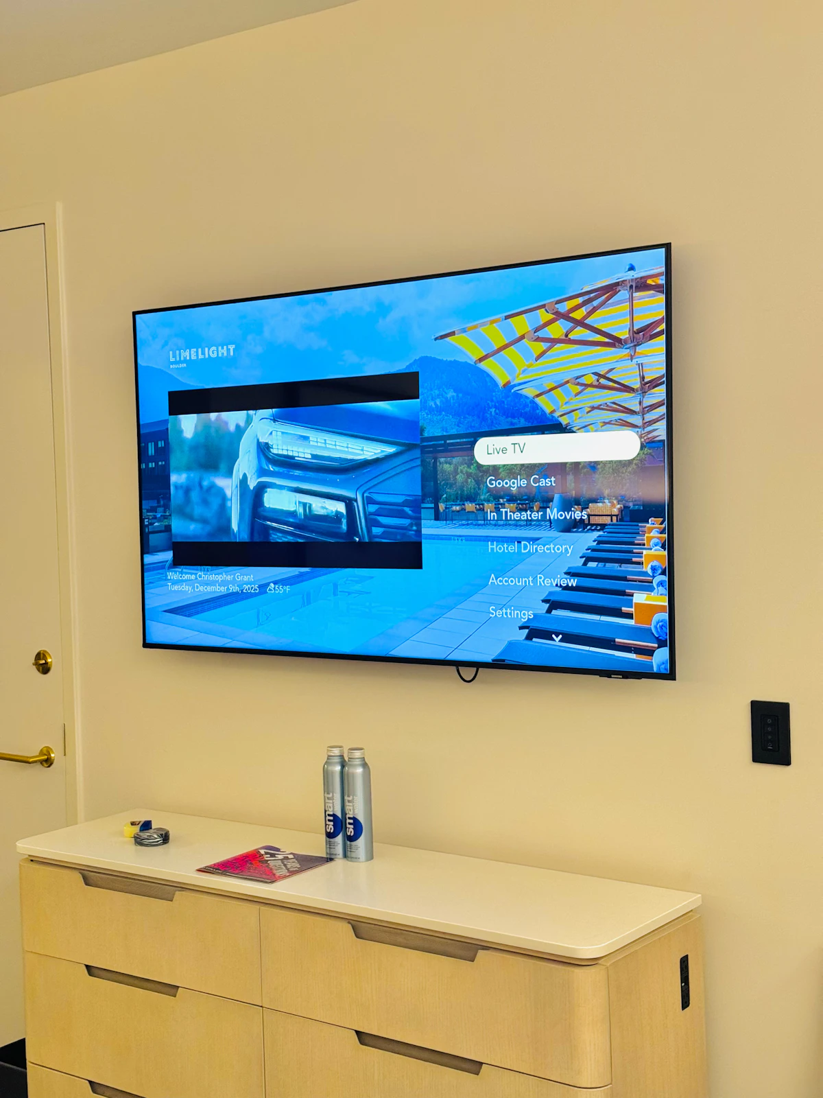 Wall-mounted flat-screen smart TV in a guest room for private viewing