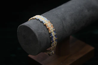 Beaded bracelet with gold accents on display.