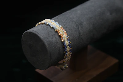 Beaded bracelet with gold accents on display.