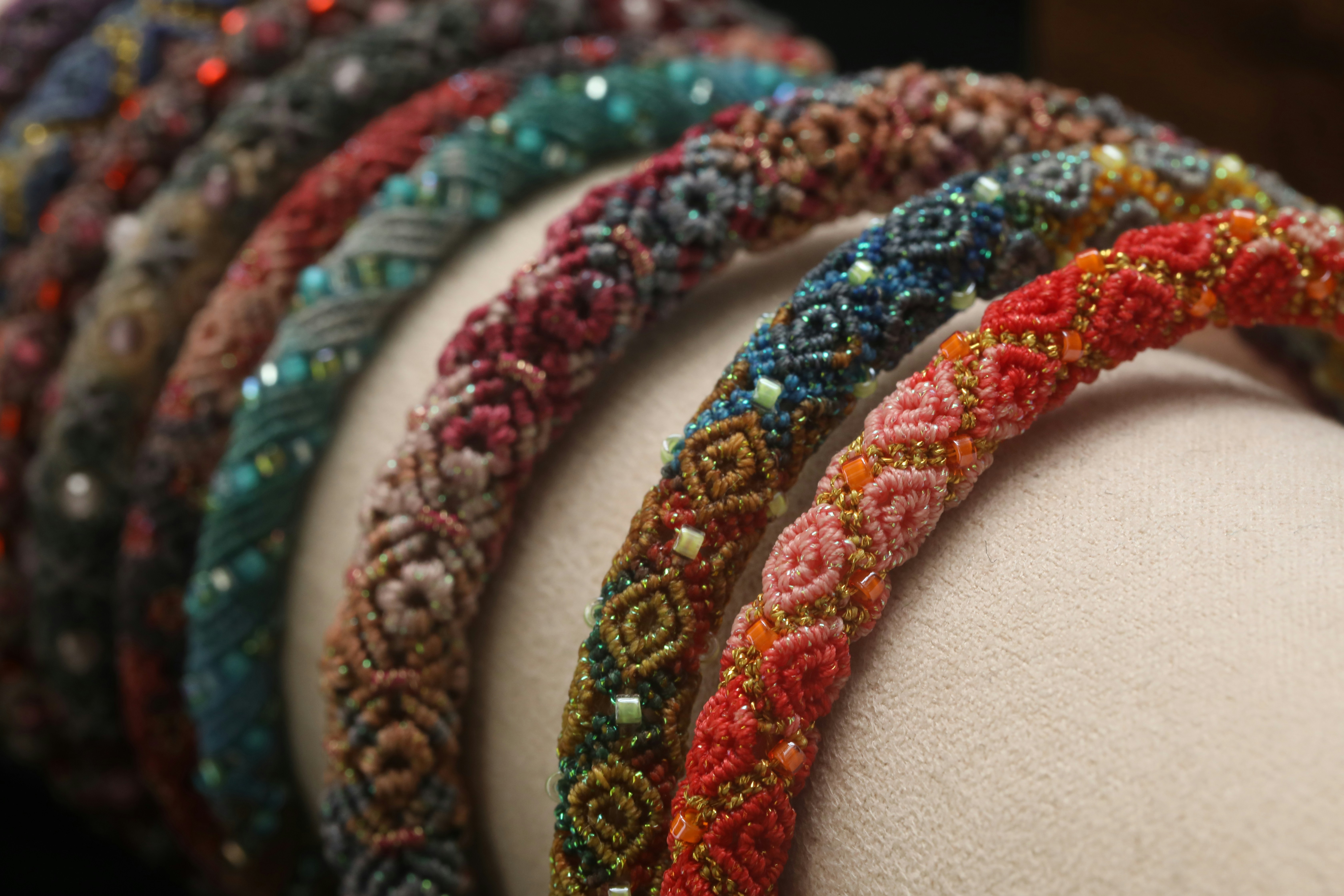 Colorful beaded headbands arranged in a row.