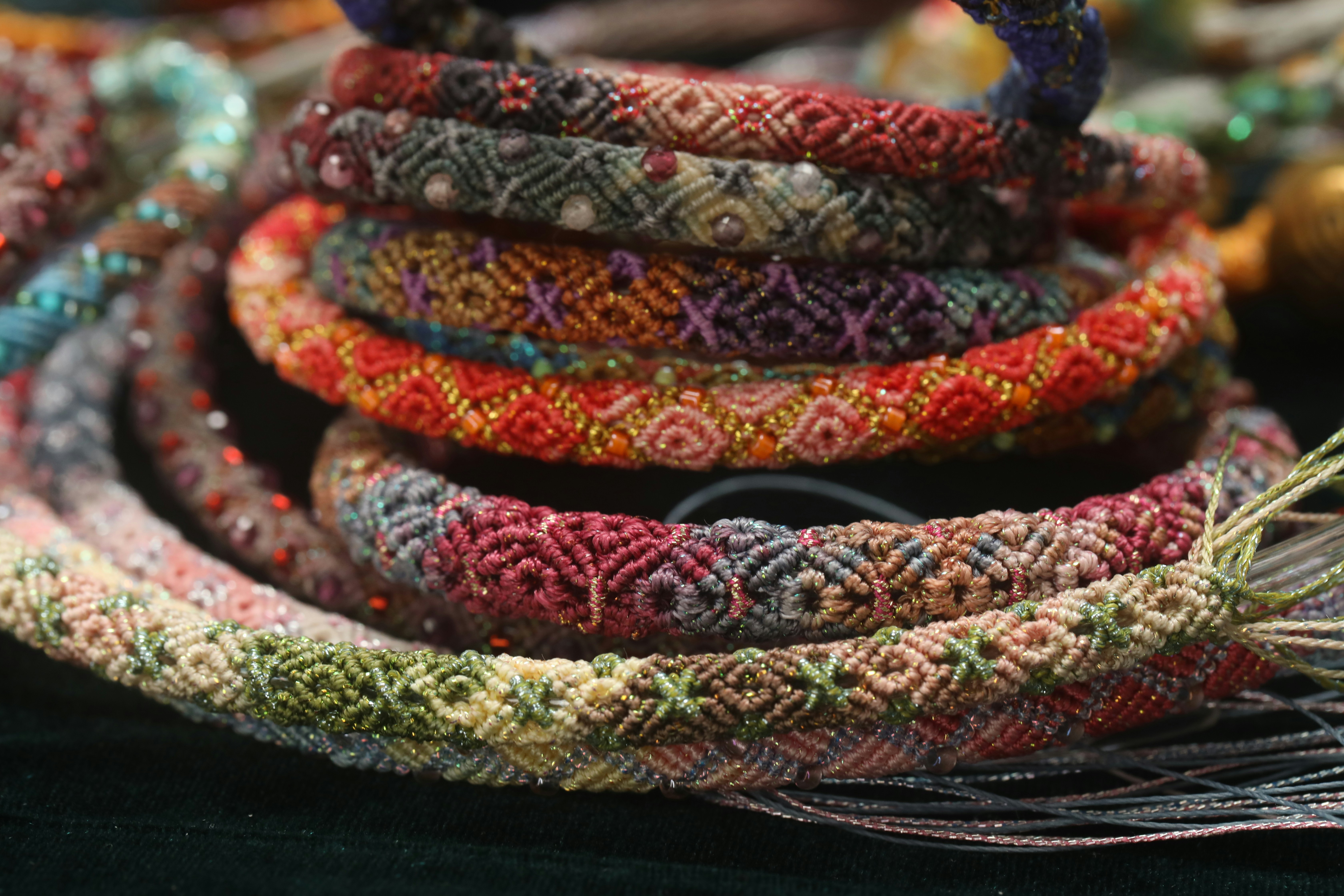 Colorful woven bracelets stacked together