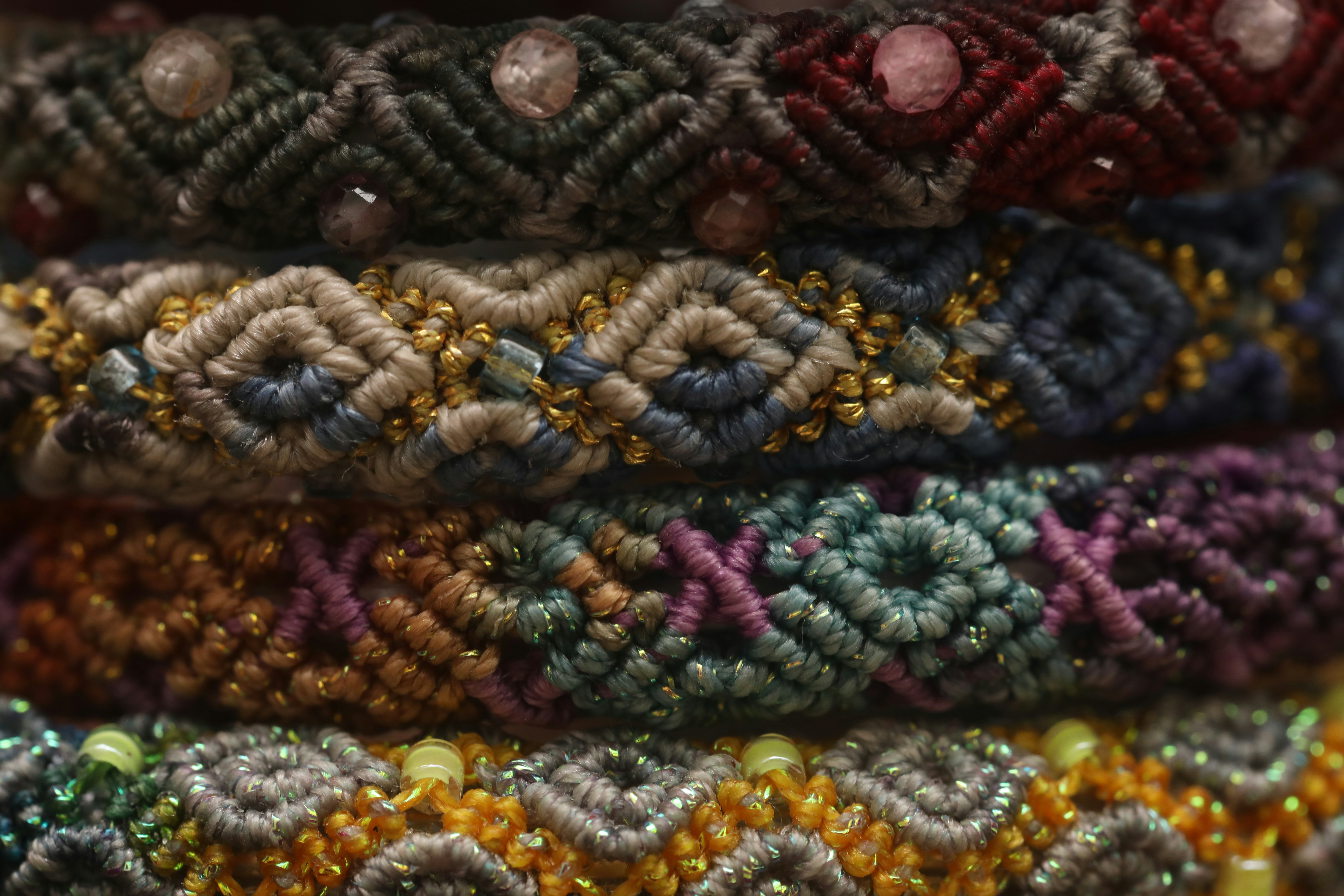 Stack of colorful, beaded friendship bracelets.