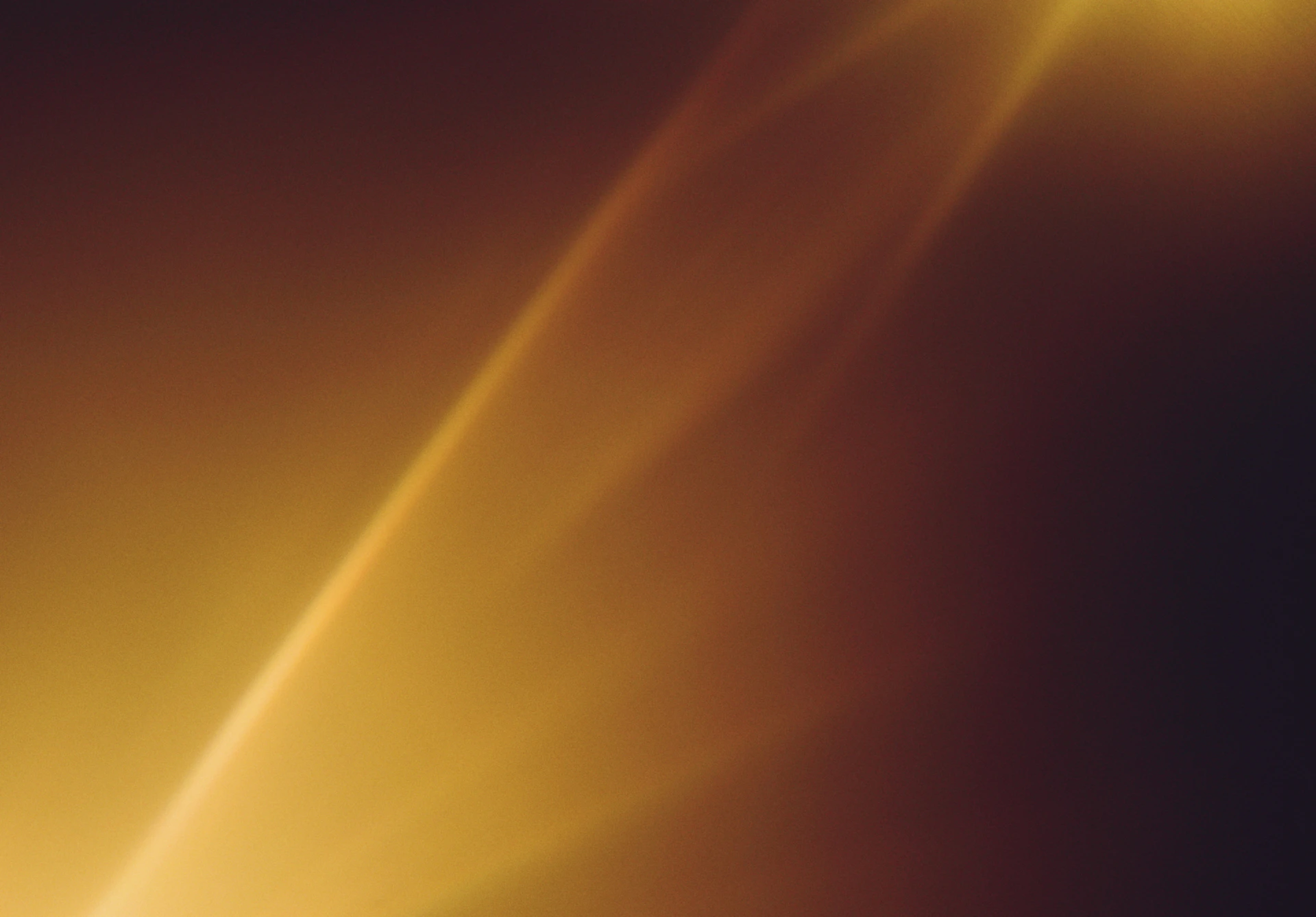 Golden light streaks across a dark background