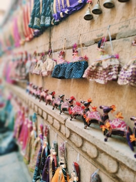 Colorful traditional indian puppets displayed on a wall.