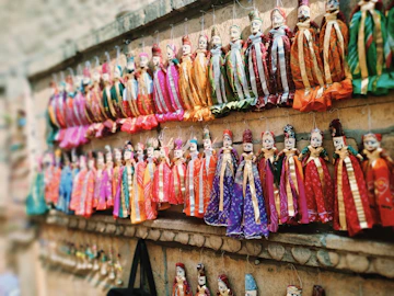 Colorful traditional puppets hanging on a wall