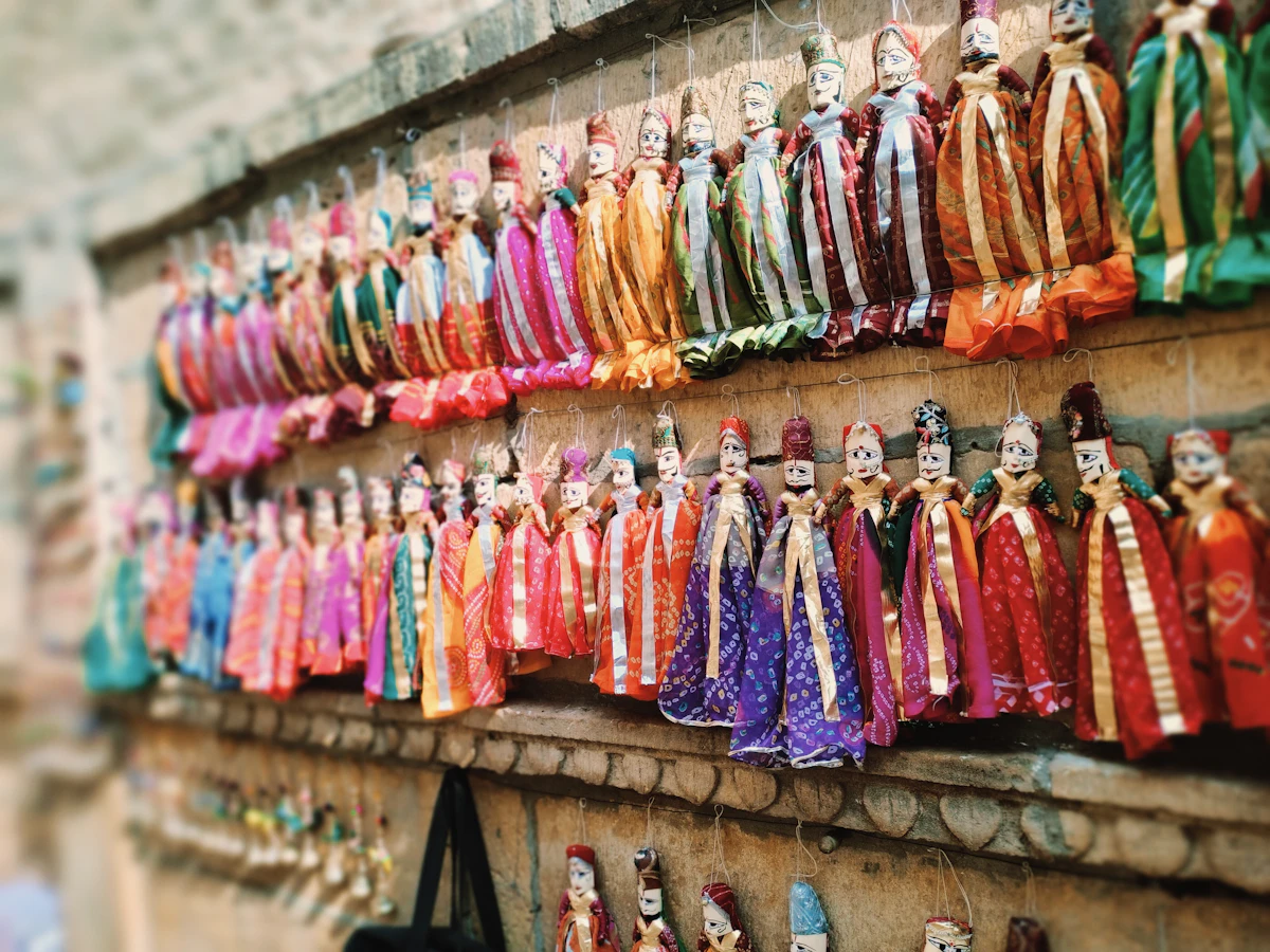 Painted wooden puppets hanging on a wall