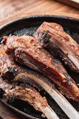 A close-up of grilled lamb chops on a platter.
