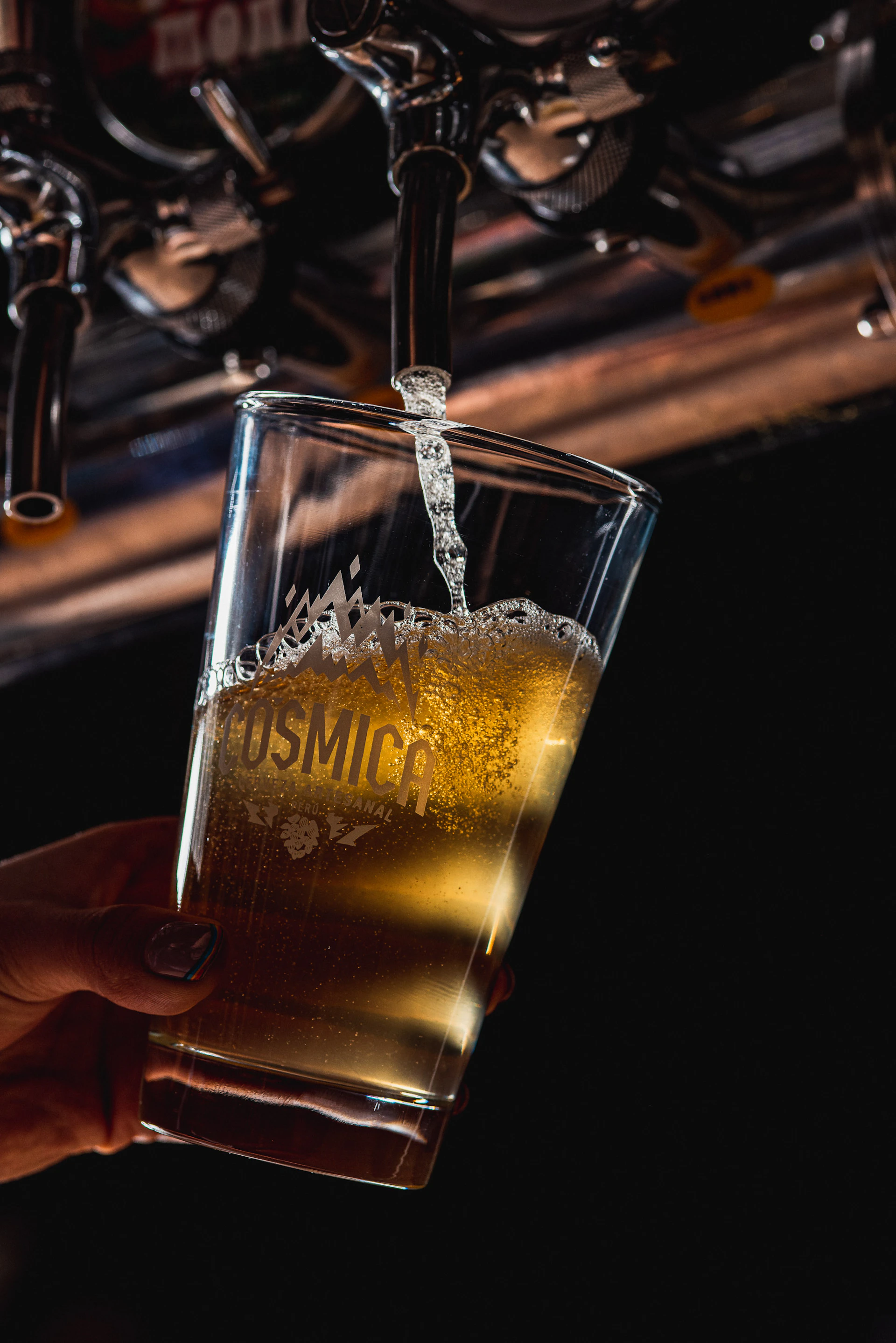 Beer being poured into a glass from a tap