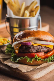 A juicy burger with cheese, lettuce, and tomato.